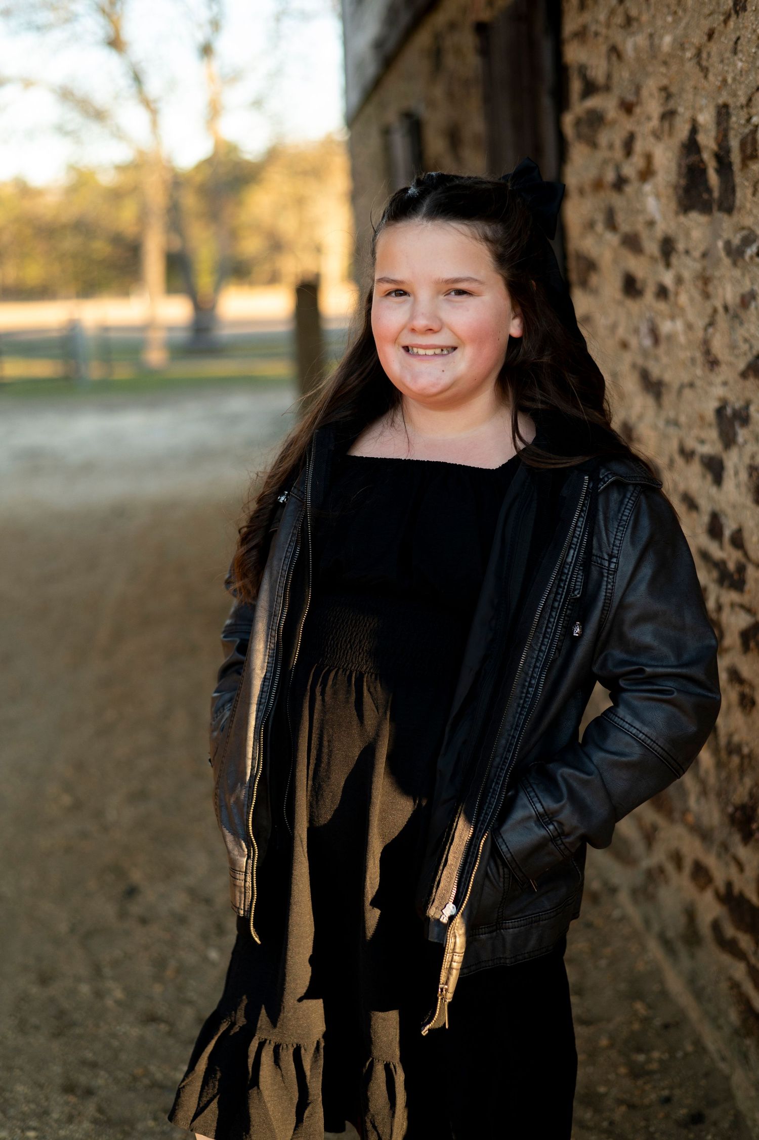 Young girl smiles for portrait at Batsto Historic Village in New Jersey.