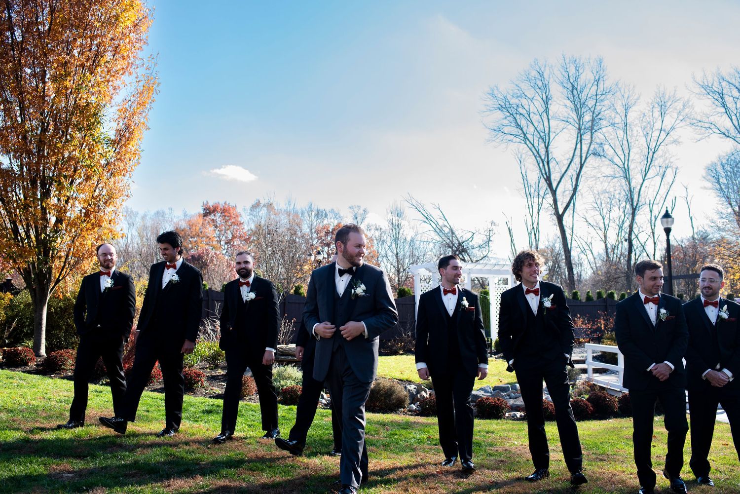 Groomsmen walk together outside at Hamilton Manor in New Jersey.