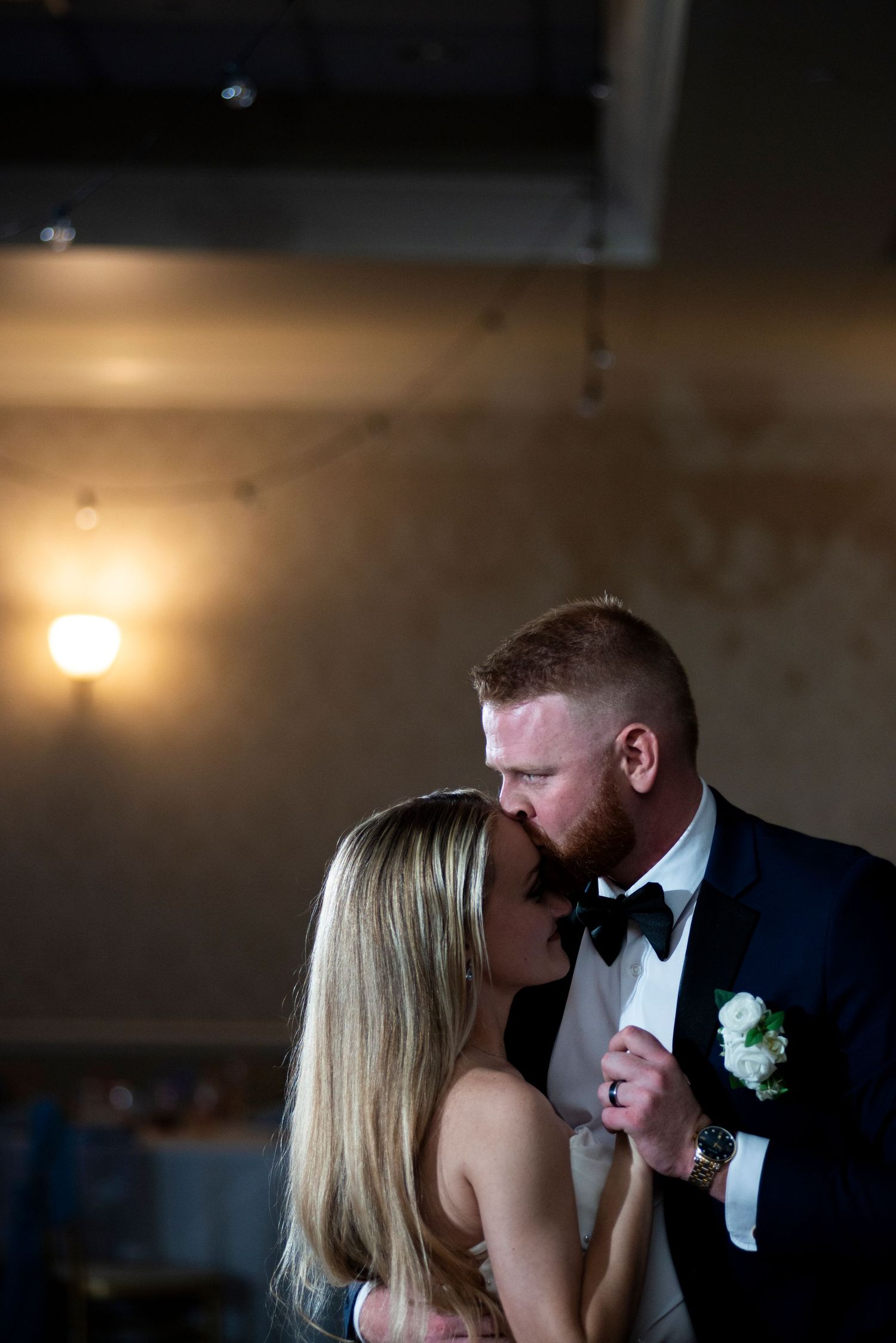 Groom kisses bride's forehead during their last dance at their wedding reception at Lazaretto Ballroom in Pennsylvania.