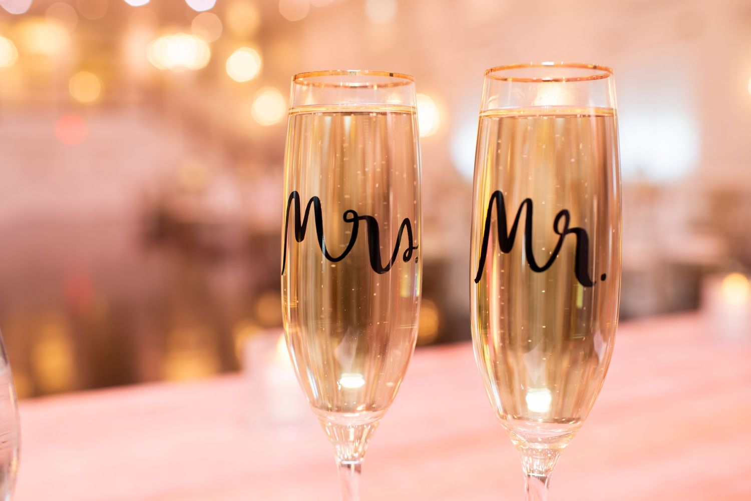 Close up of champagne glasses with Mrs. and Mr. printed on them in ballroom at wedding reception at Hamilton Manor in New Jersey.