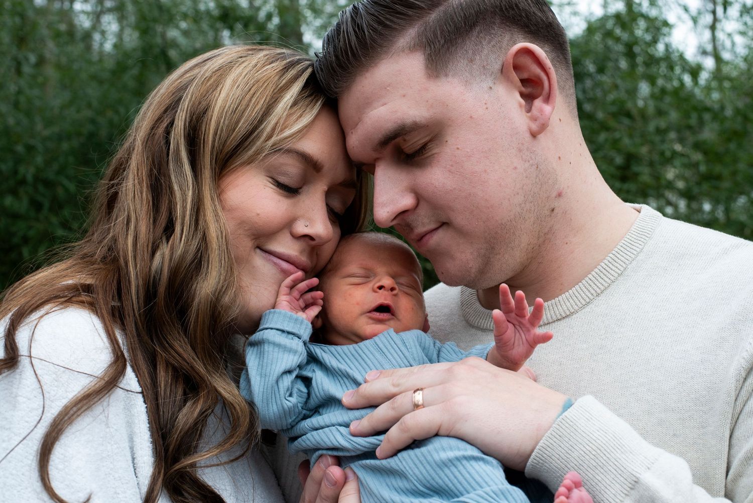 New parents close their eyes as they embrace their newborn son outside of their Medford, New Jersey home.