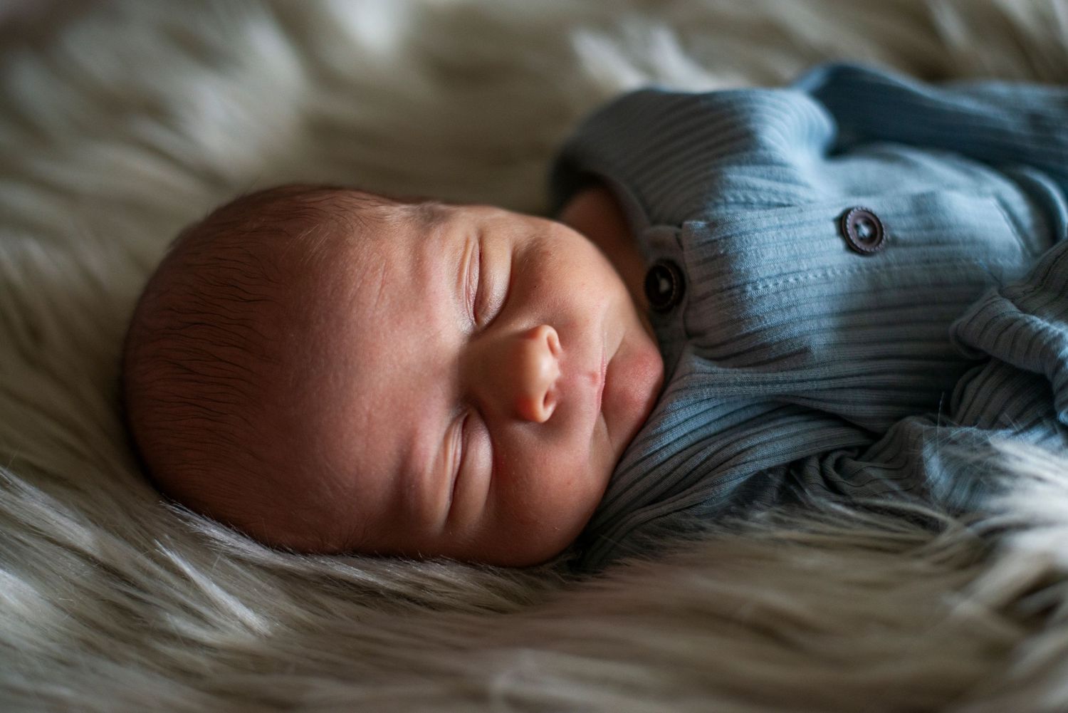 Close up newborn portrait on furry rug.