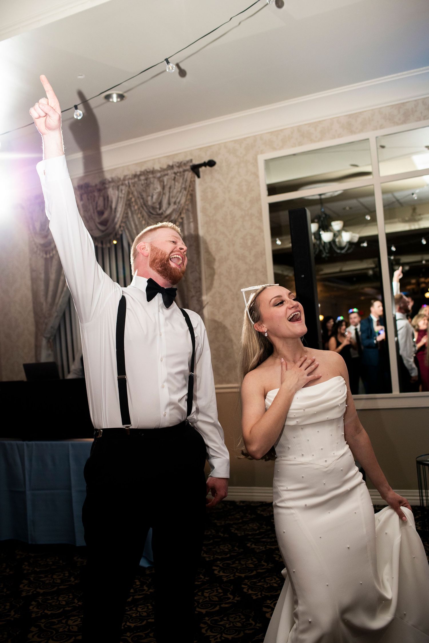 Bride and groom hype during wedding reception at Lazaretto Ballroom in Pennsylvania.