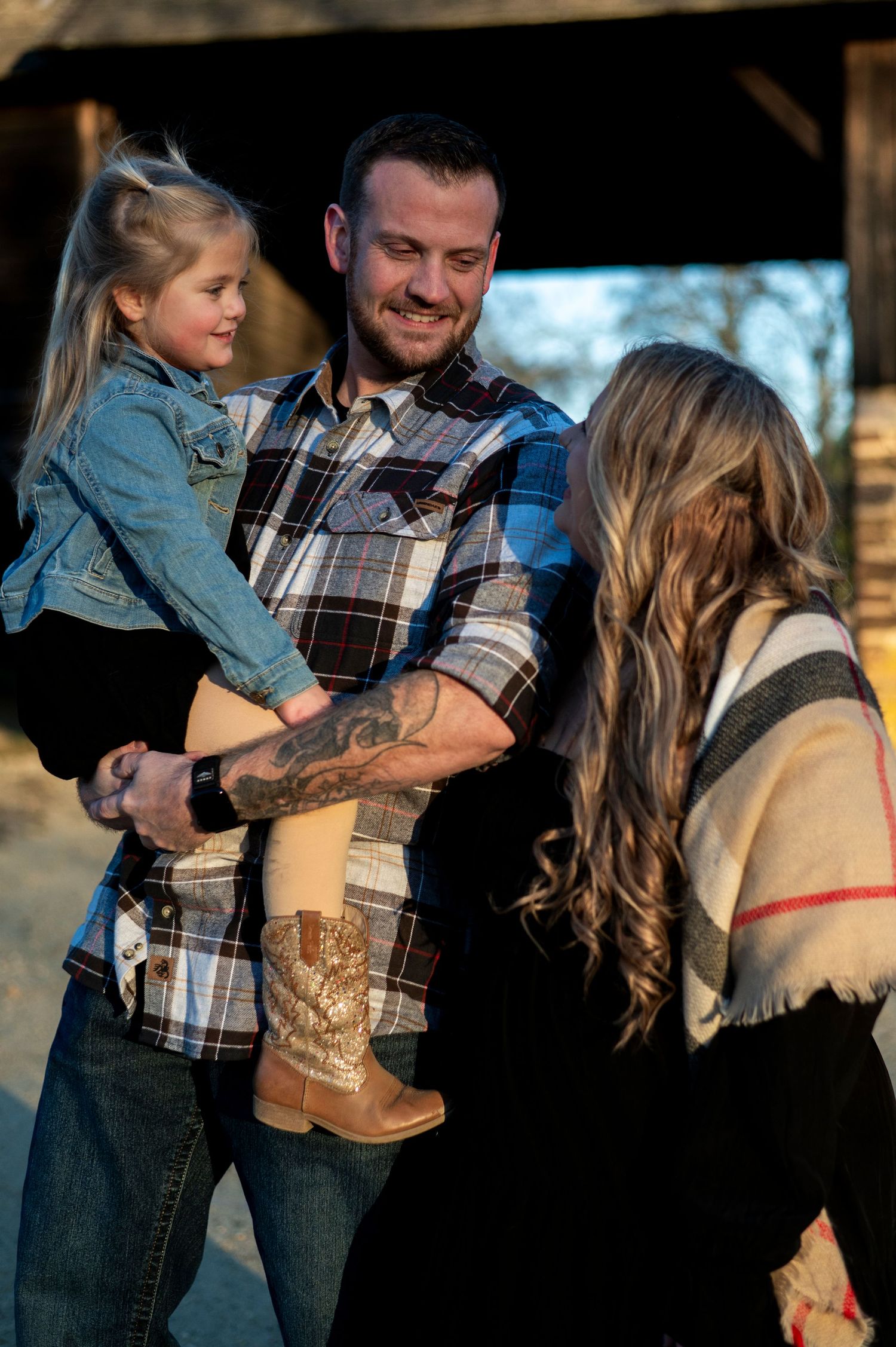 Family of three smile at one another at Batsto Historic Village in New Jersey.