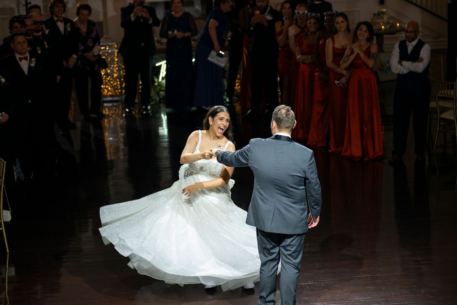 Bride and groom twirl in the spotlight during their first dance at their wedding reception at Hamilton Manor in New Jersey.