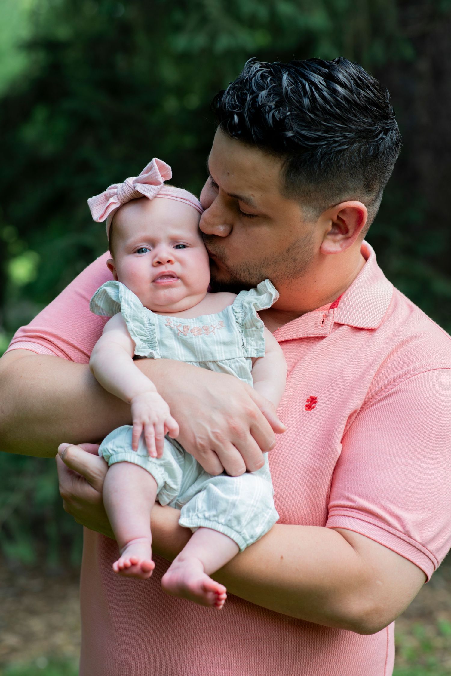 Dad kisses infant daughter's cheek at Colonial Park in Somerset, NJ.