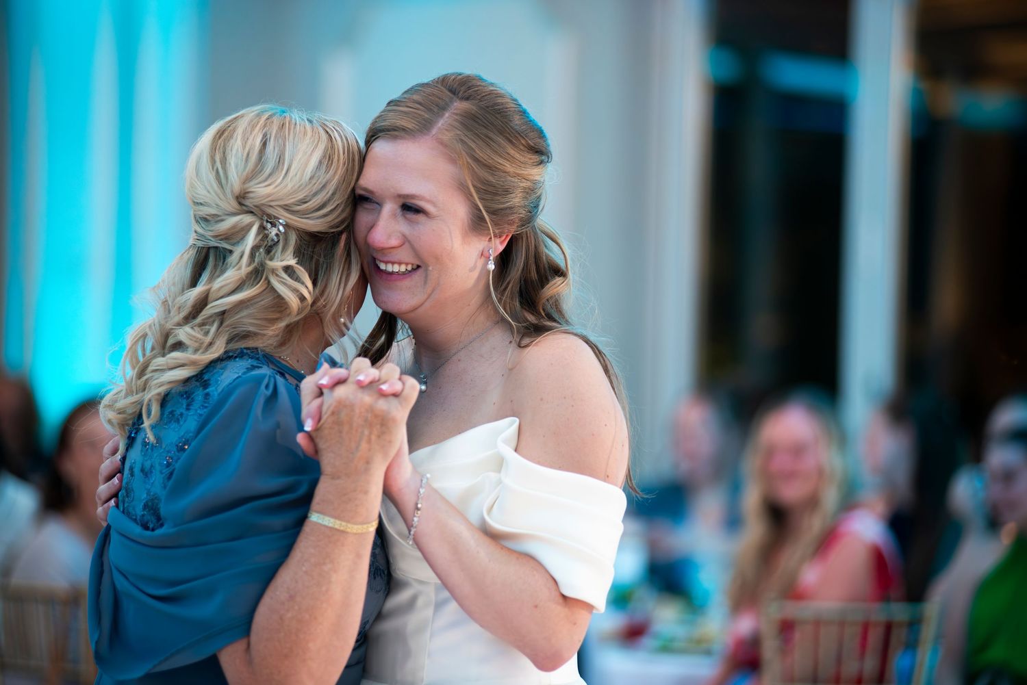 Bride smiles while dancing with her mother during wedding reception at The Mansion in Voorhees, New Jersey.