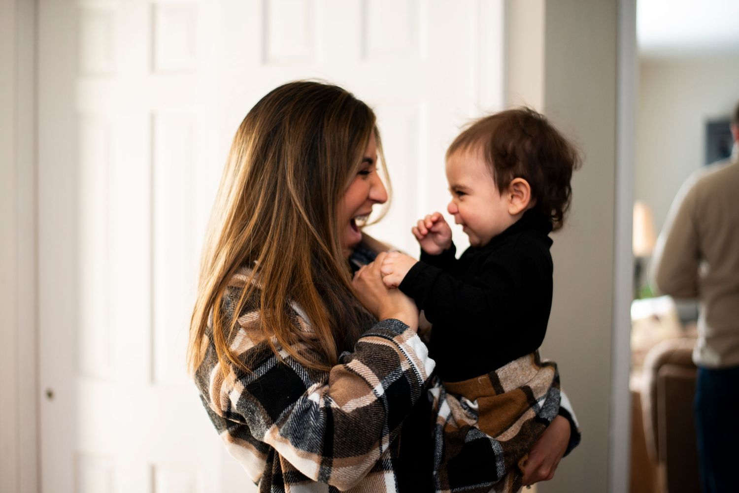 Mother and daughter smile and laugh at each other at home in Cherry Hill, NJ.
