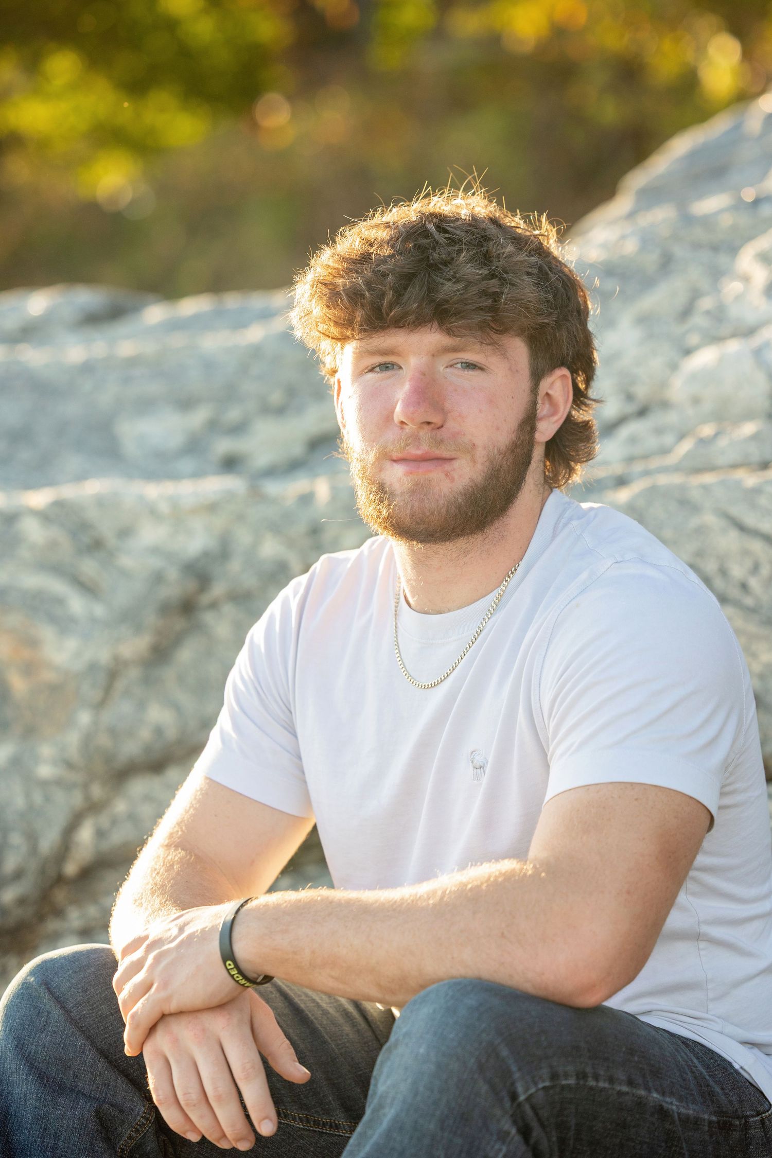 Athletic portrait on rocky terrain during golden hour sunset.