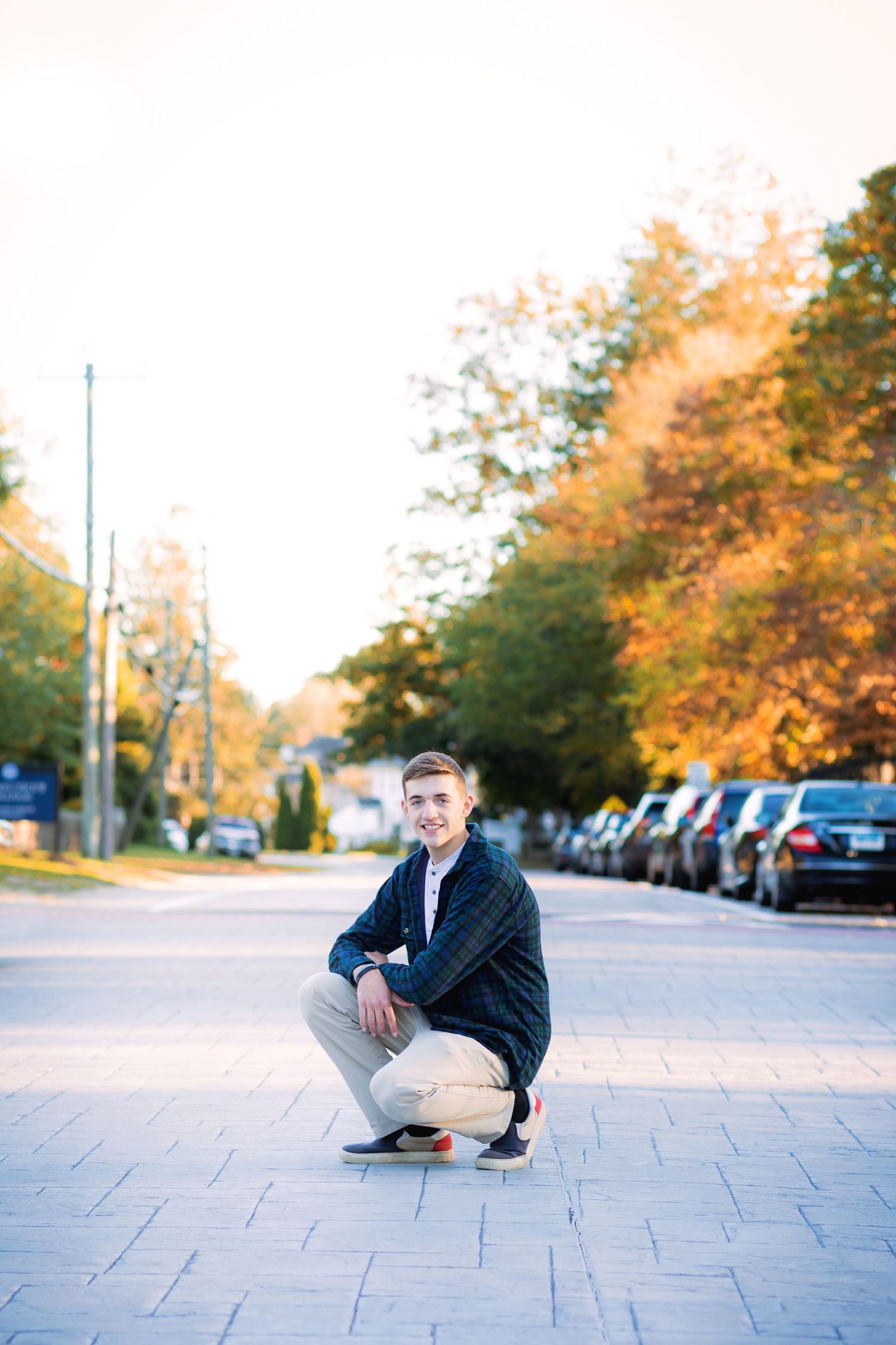 Professional portrait series showing a person in a dark suit sitting on concrete steps during golden hour.