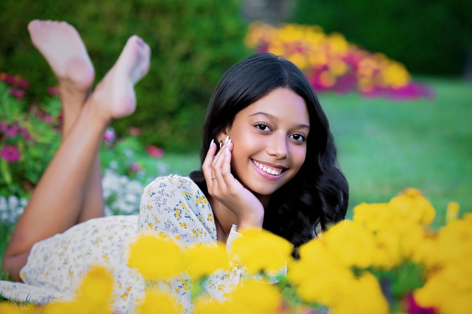 Outdoor portrait with yellow flowers in a garden setting.