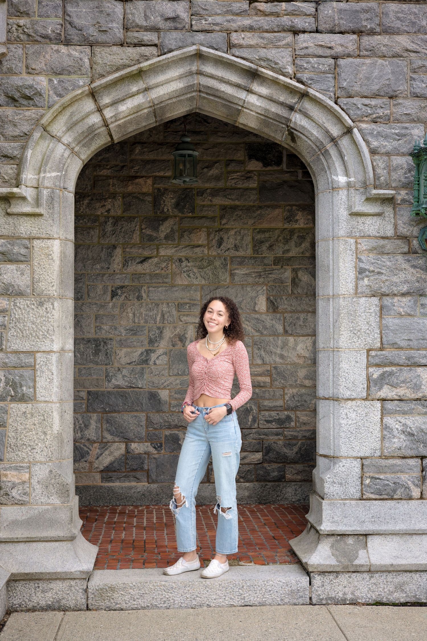 A series of four stone archway alcoves with someone posing in different positions against the architectural backdrop.