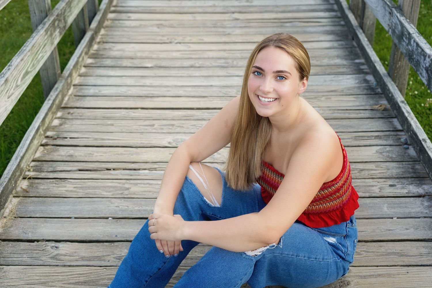 A series of outdoor portrait photos taken on a wooden boardwalk surrounded by green foliage.