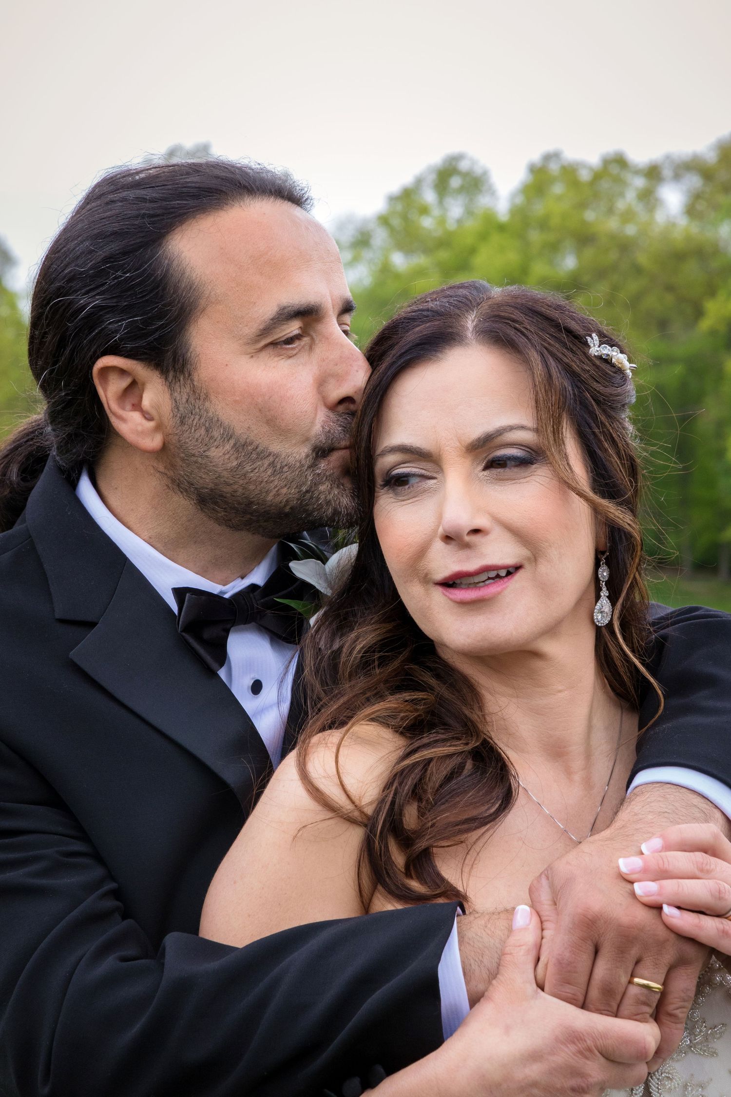 A romantic sequence of wedding photos showing tender moments between newlyweds in an outdoor garden setting.
