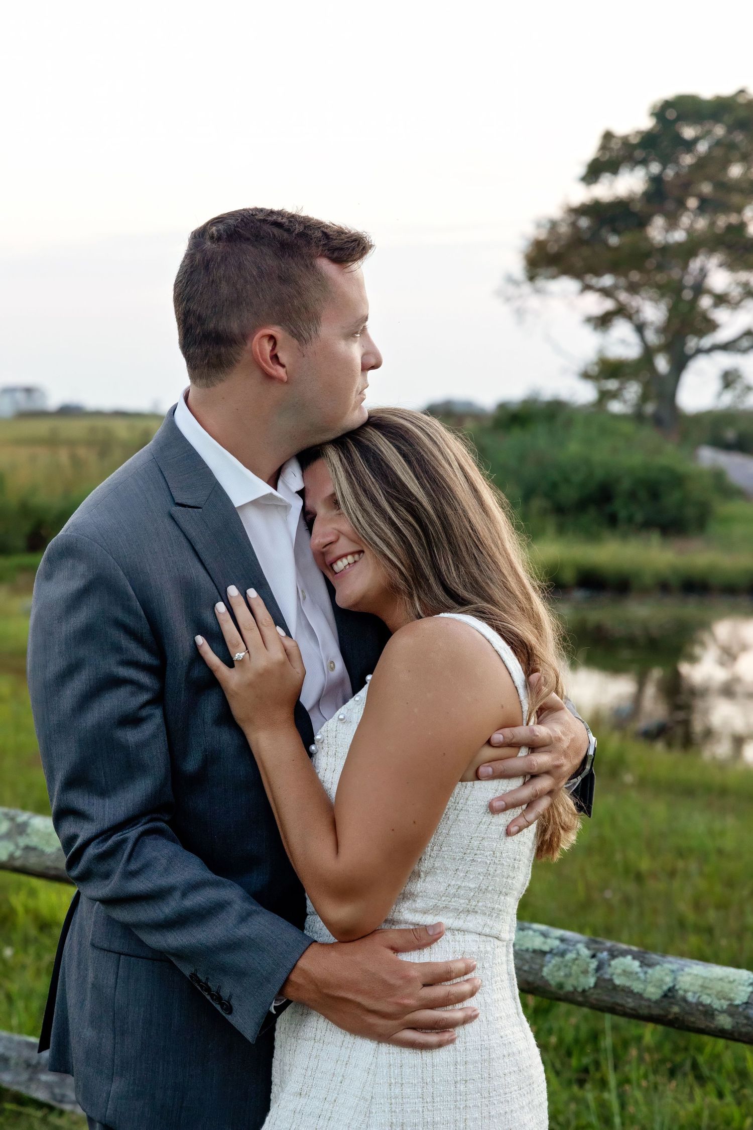 Couple in formal attire sharing intimate embraces in outdoor setting.