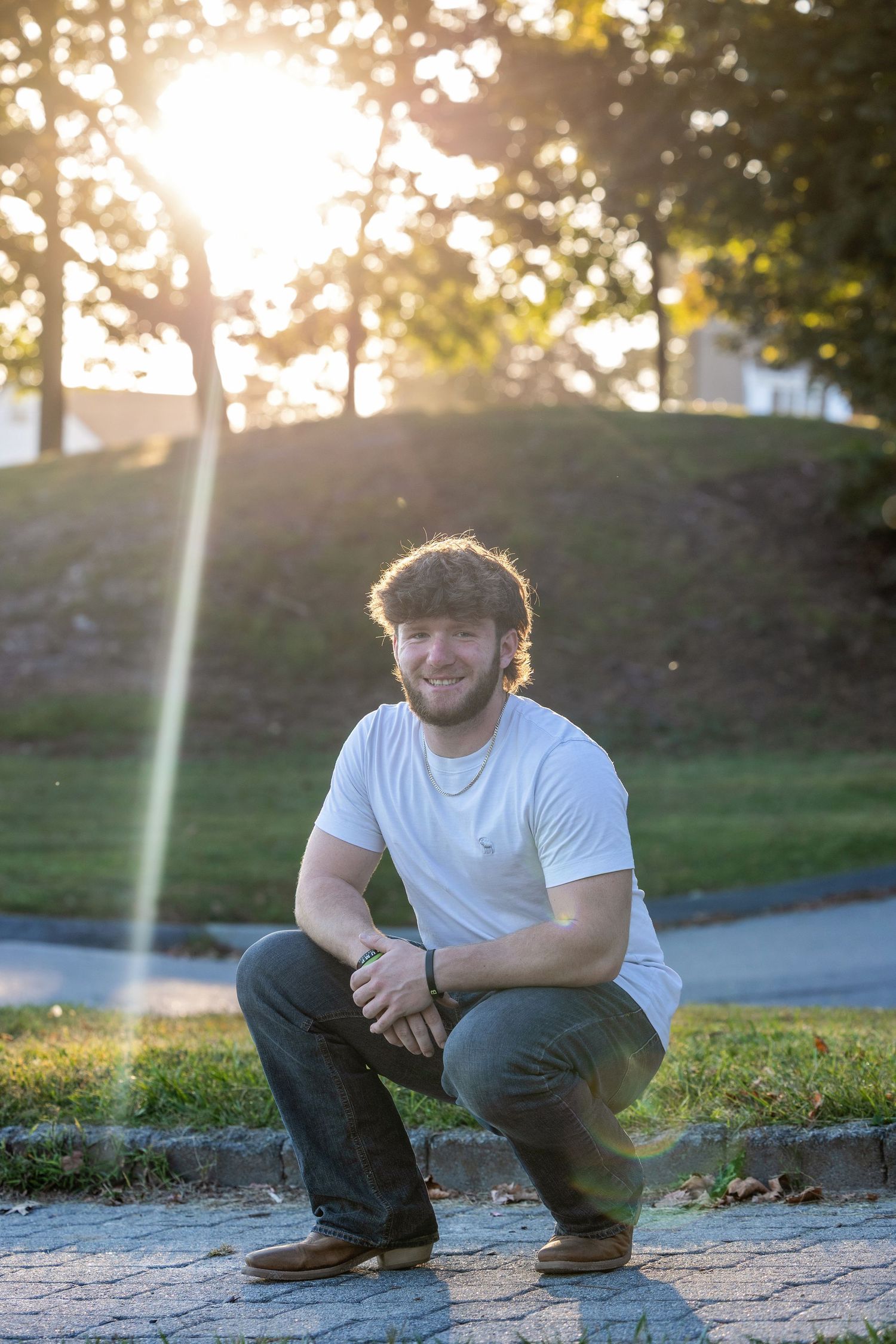 Casual outdoor portrait session during sunset with natural lighting.