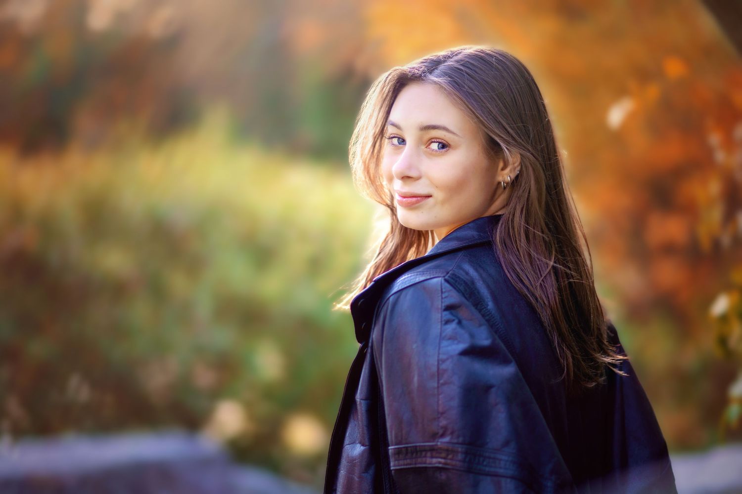 A figure stands in an autumn forest setting with golden foliage and warm sunlight filtering through the trees.