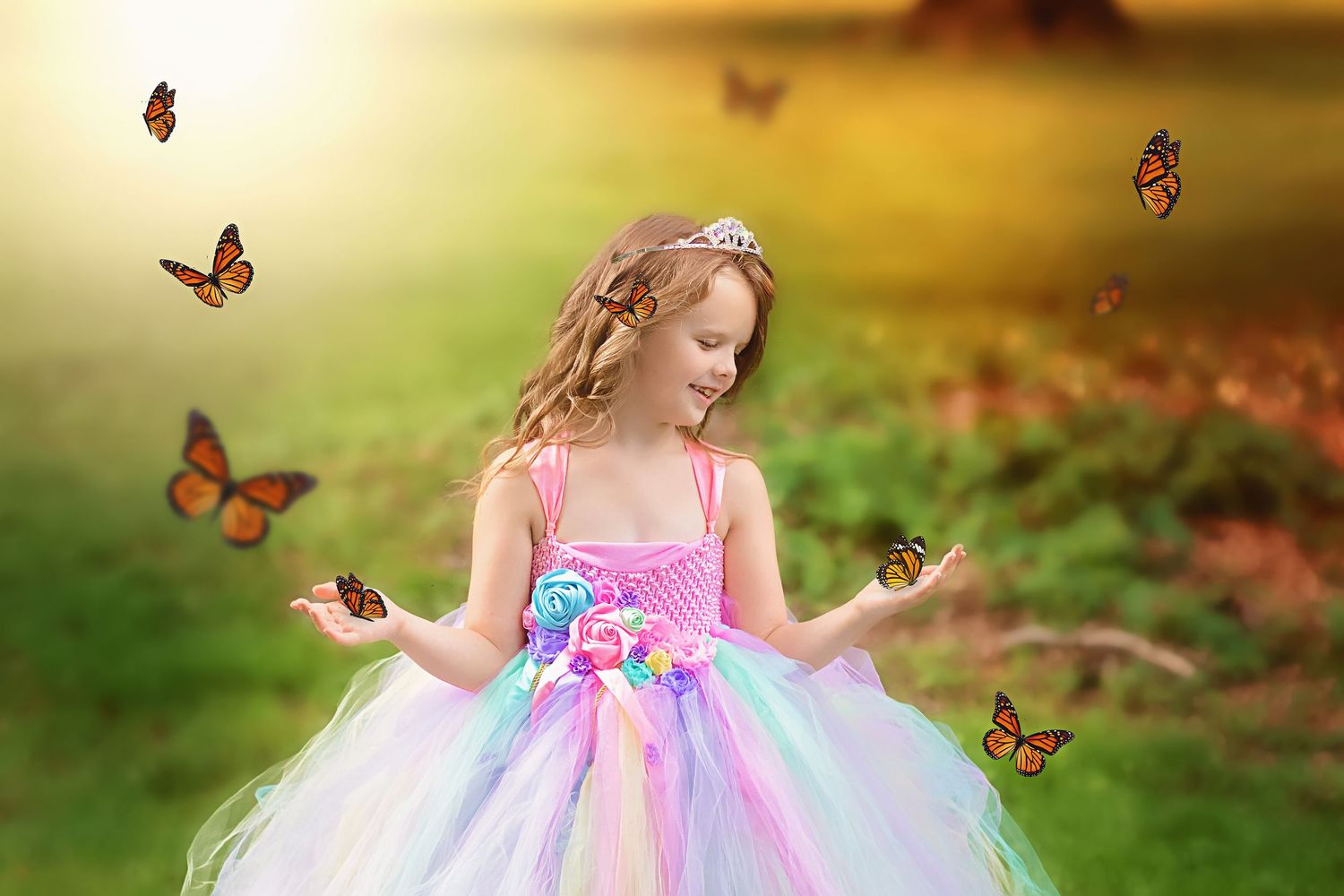Monarch butterflies flutter around a pink and purple tulle dress in a magical garden setting.