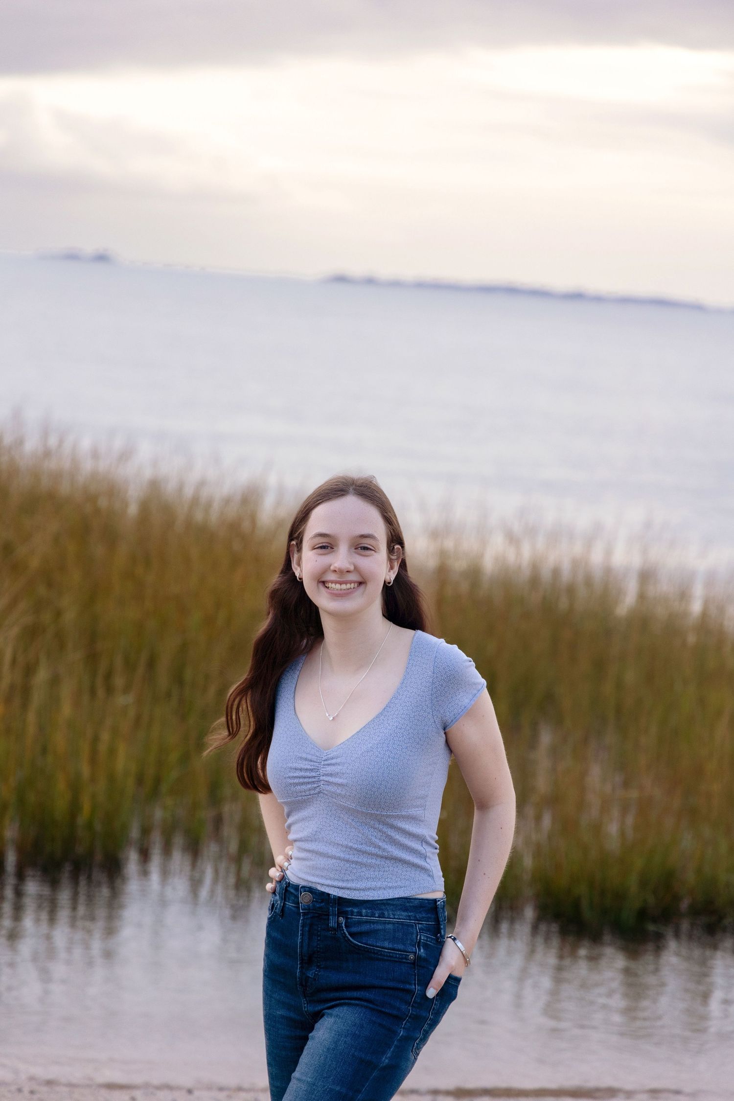 Casual portrait session at sunset by the marsh with tall grass.