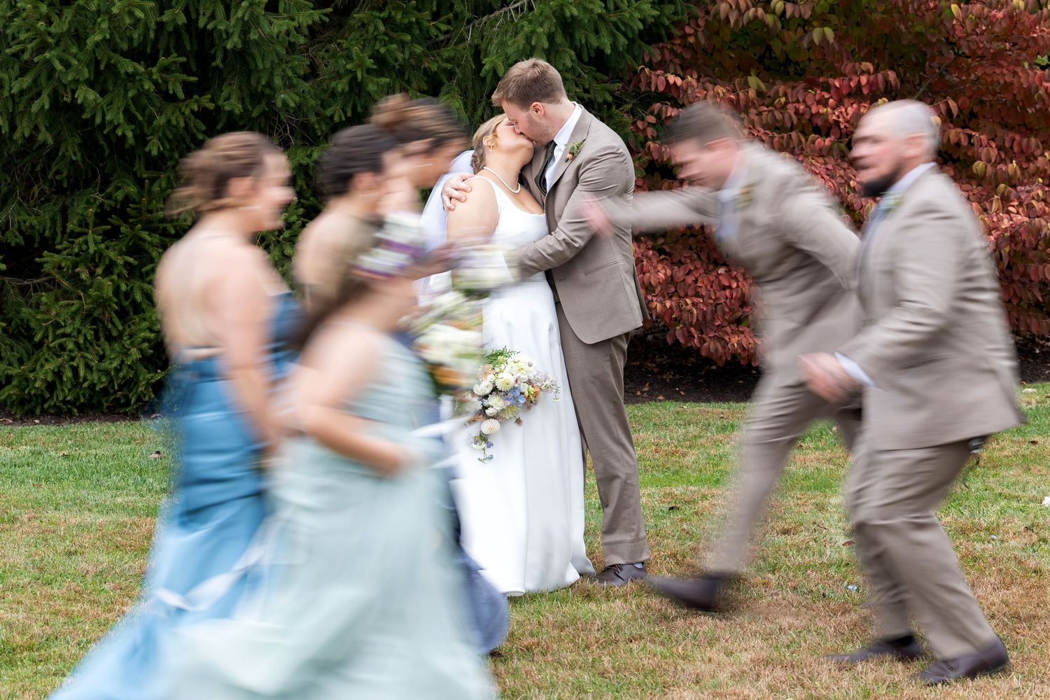 Motion blur captures dancing and movement at an outdoor celebration.