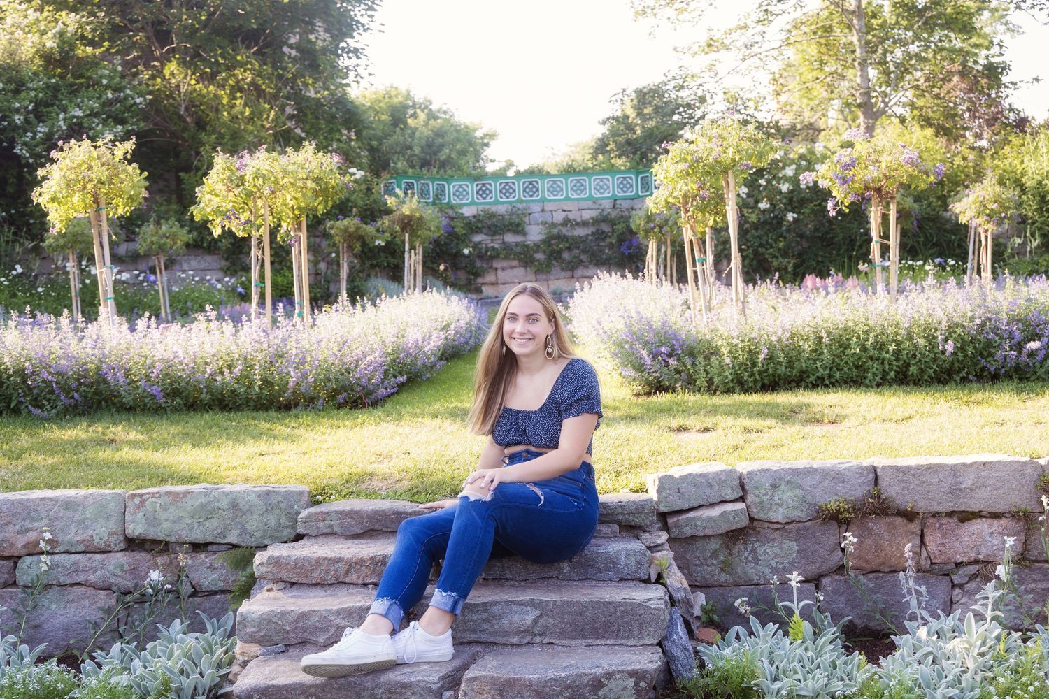 A series of outdoor portrait photos taken at sunset against stone walls and wildflower fields.