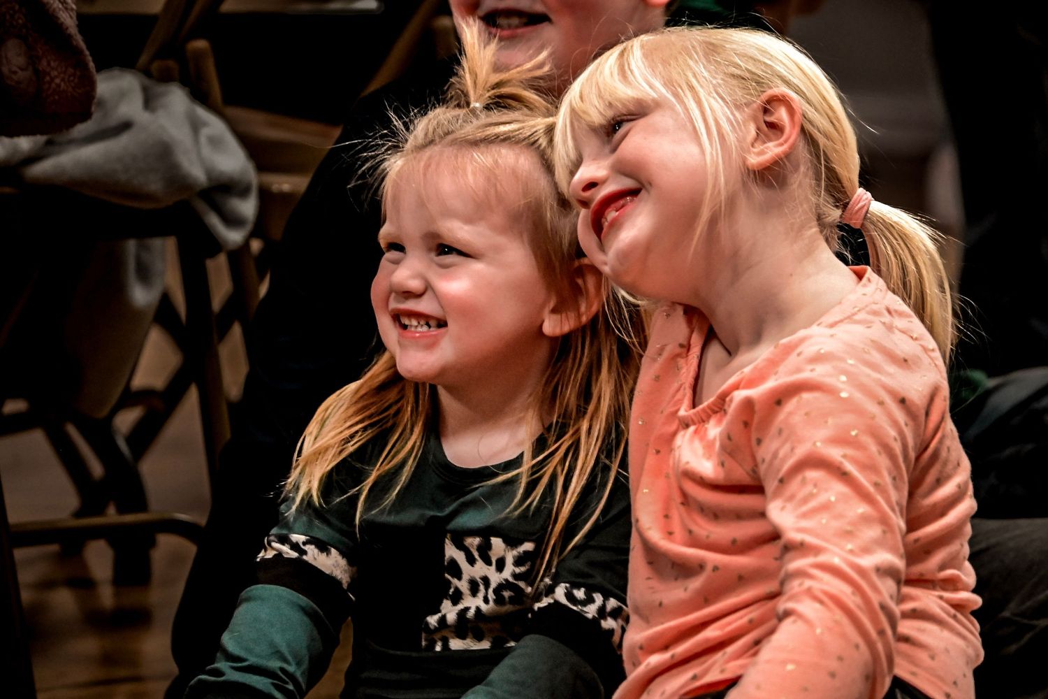 Children laughing and smiling together in a candid group moment.