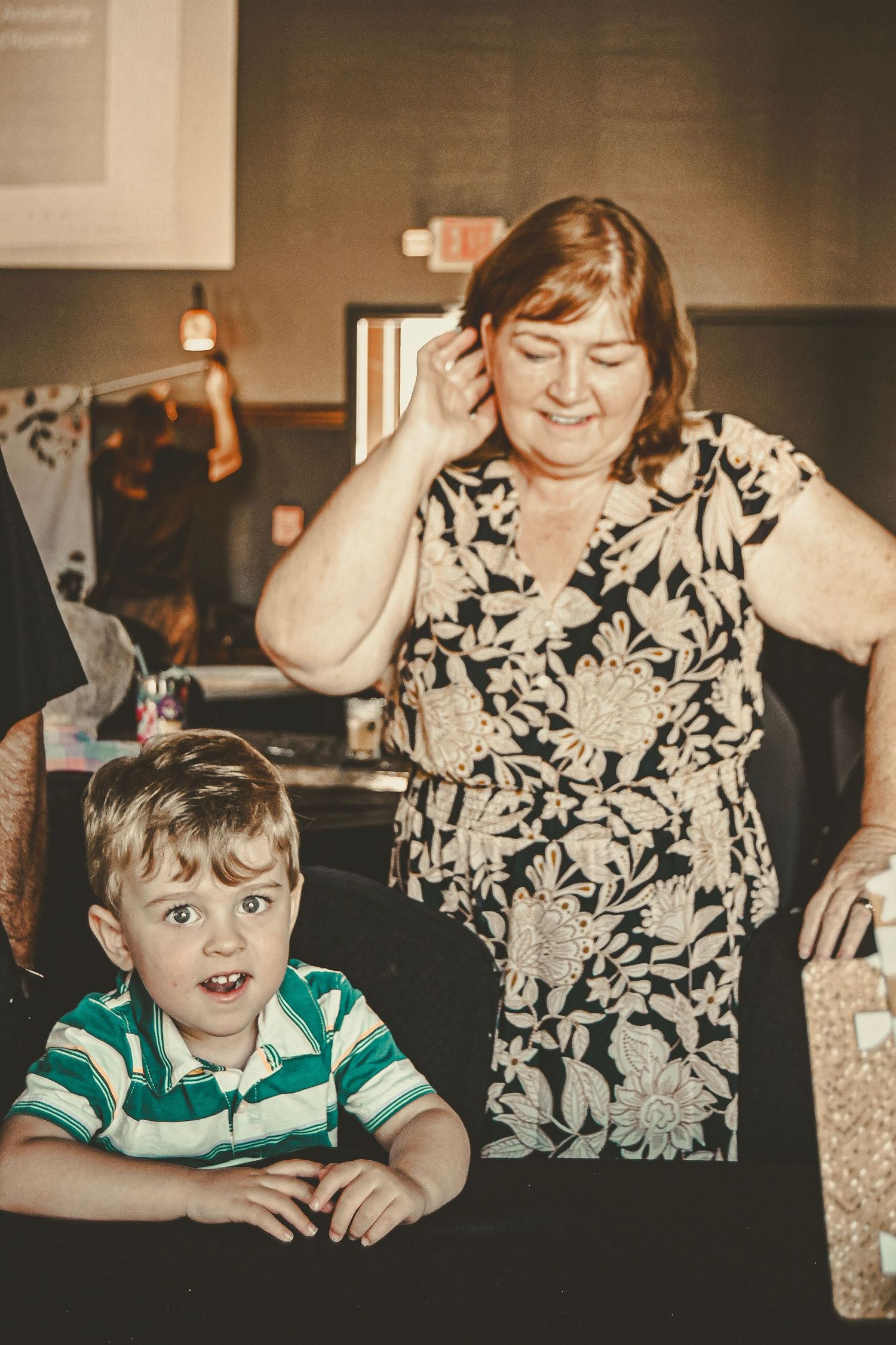 Candid family moment captured at a dining table with warm ambient lighting.