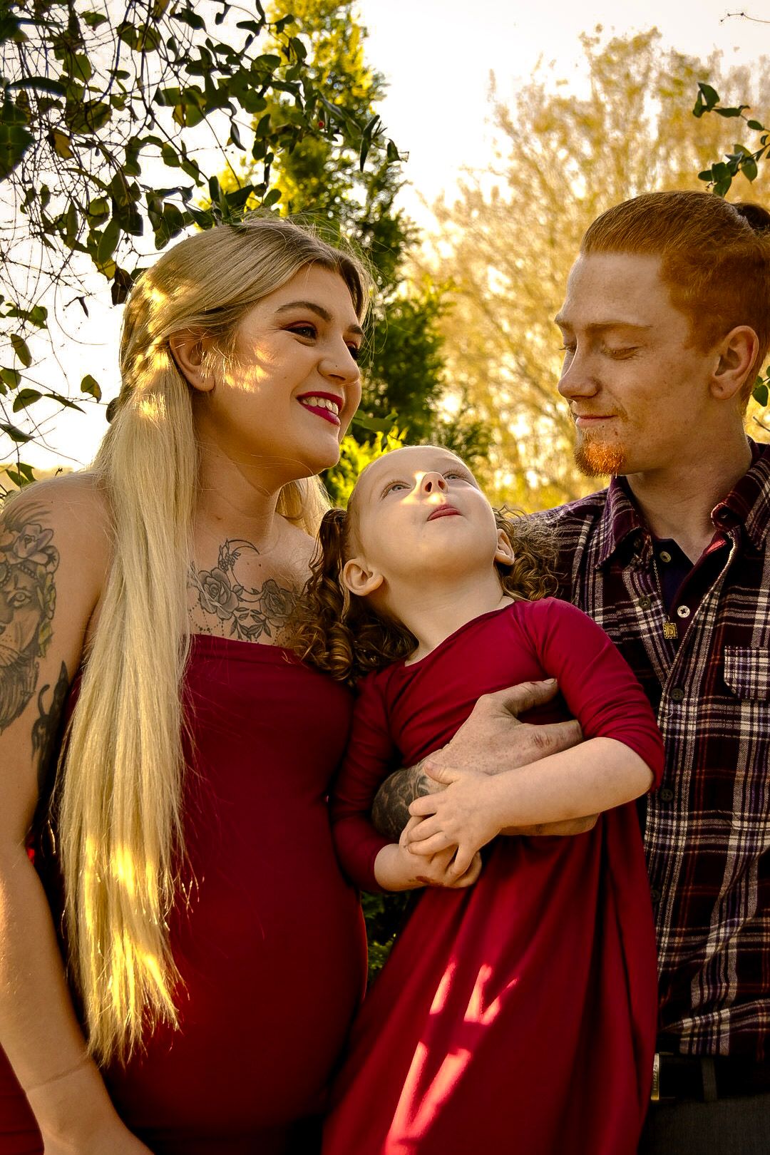 A couple in a red sweater and plaid shirt share intimate moments in a series of outdoor autumn photos.