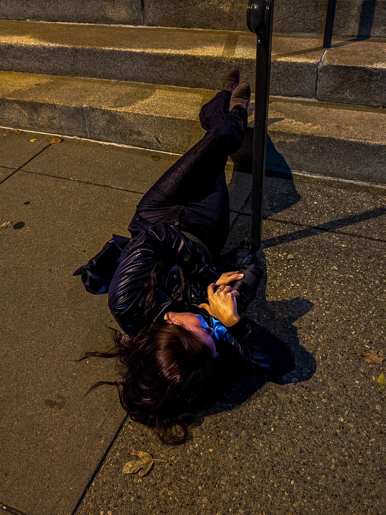 A sequence of photos showing someone lying on a dark sidewalk at night illuminated by street lighting.