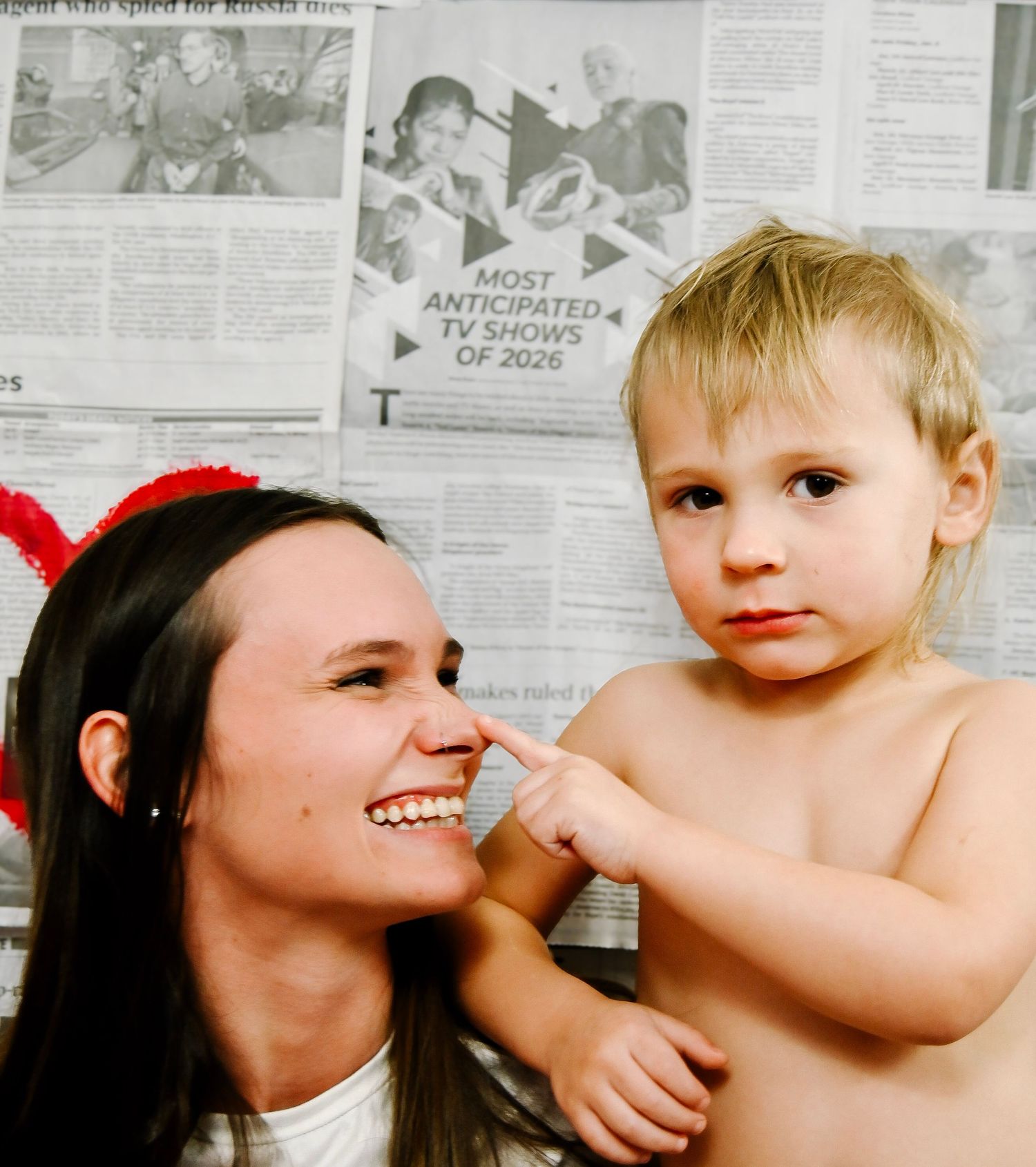 A series of five black and white newspaper photos showing candid parent-child moments in sequence.