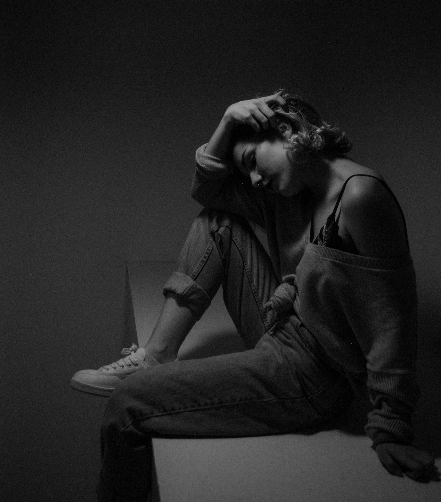Dramatic black and white portrait series showing intimate poses in low light.