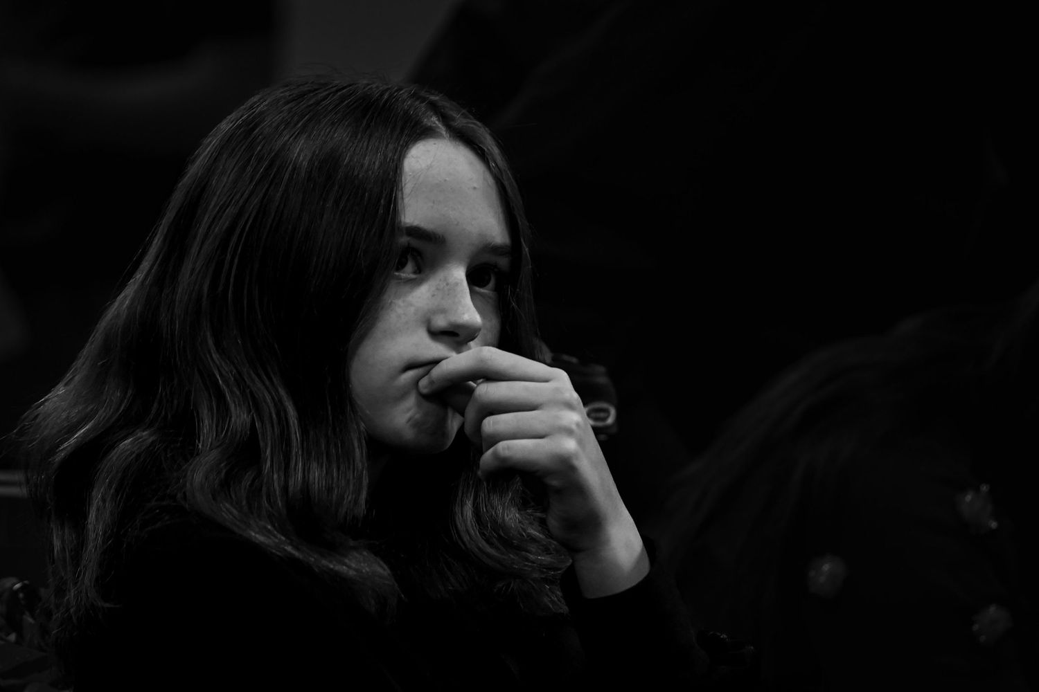 Dramatic low-key portrait series with deep shadows creating a moody atmosphere.