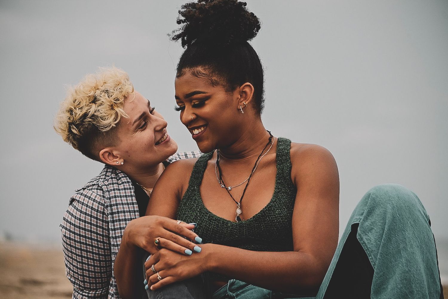 A tender moment captured in color photography showing two people in casual attire embracing outdoors.