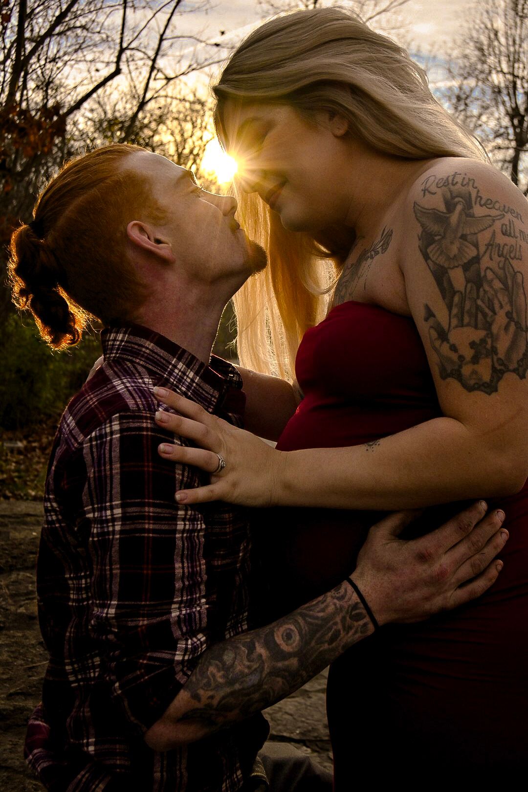A romantic sunset silhouette of two people embracing outdoors.