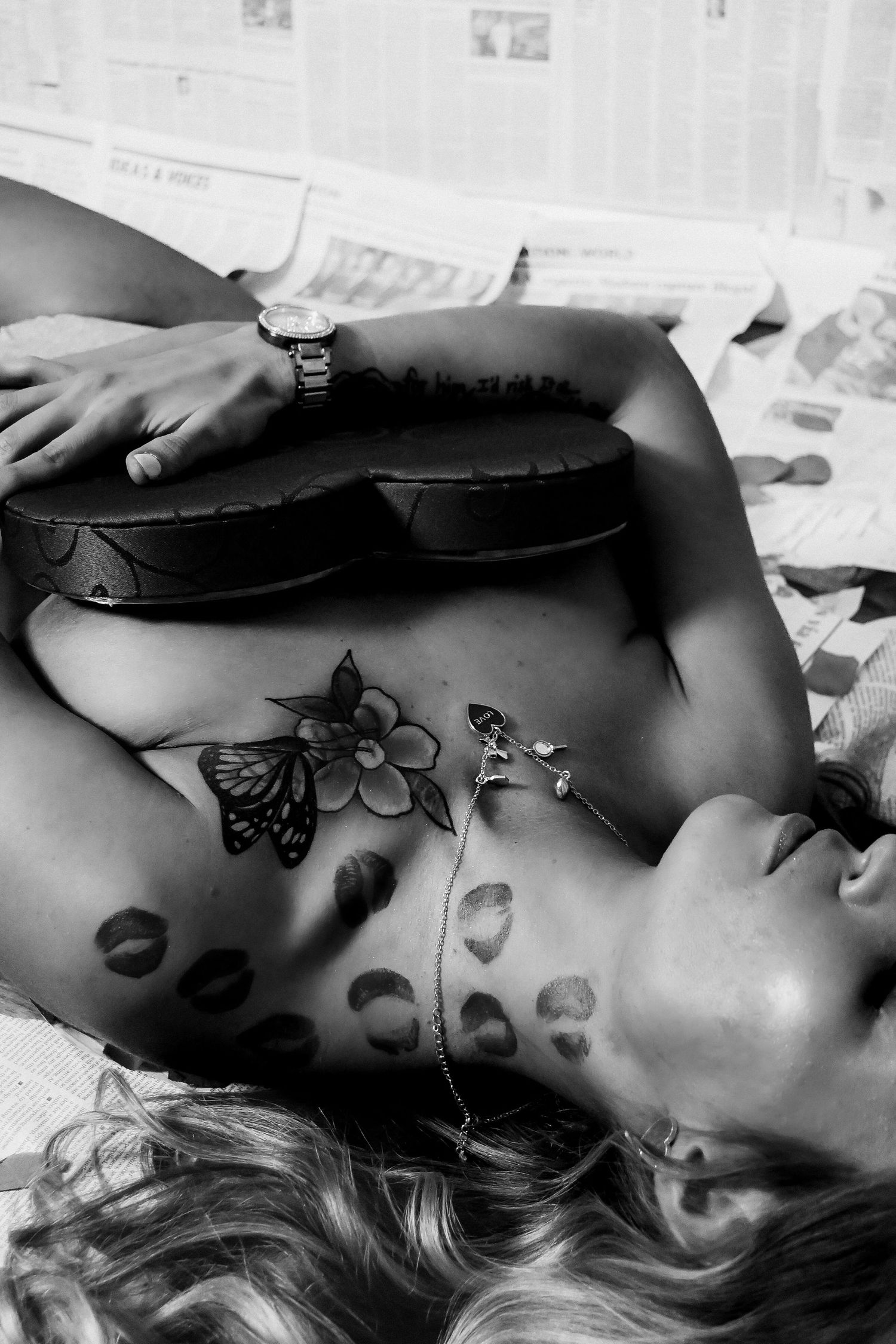 Black and white artistic photos showing delicate butterfly tattoos in an intimate portrait series.