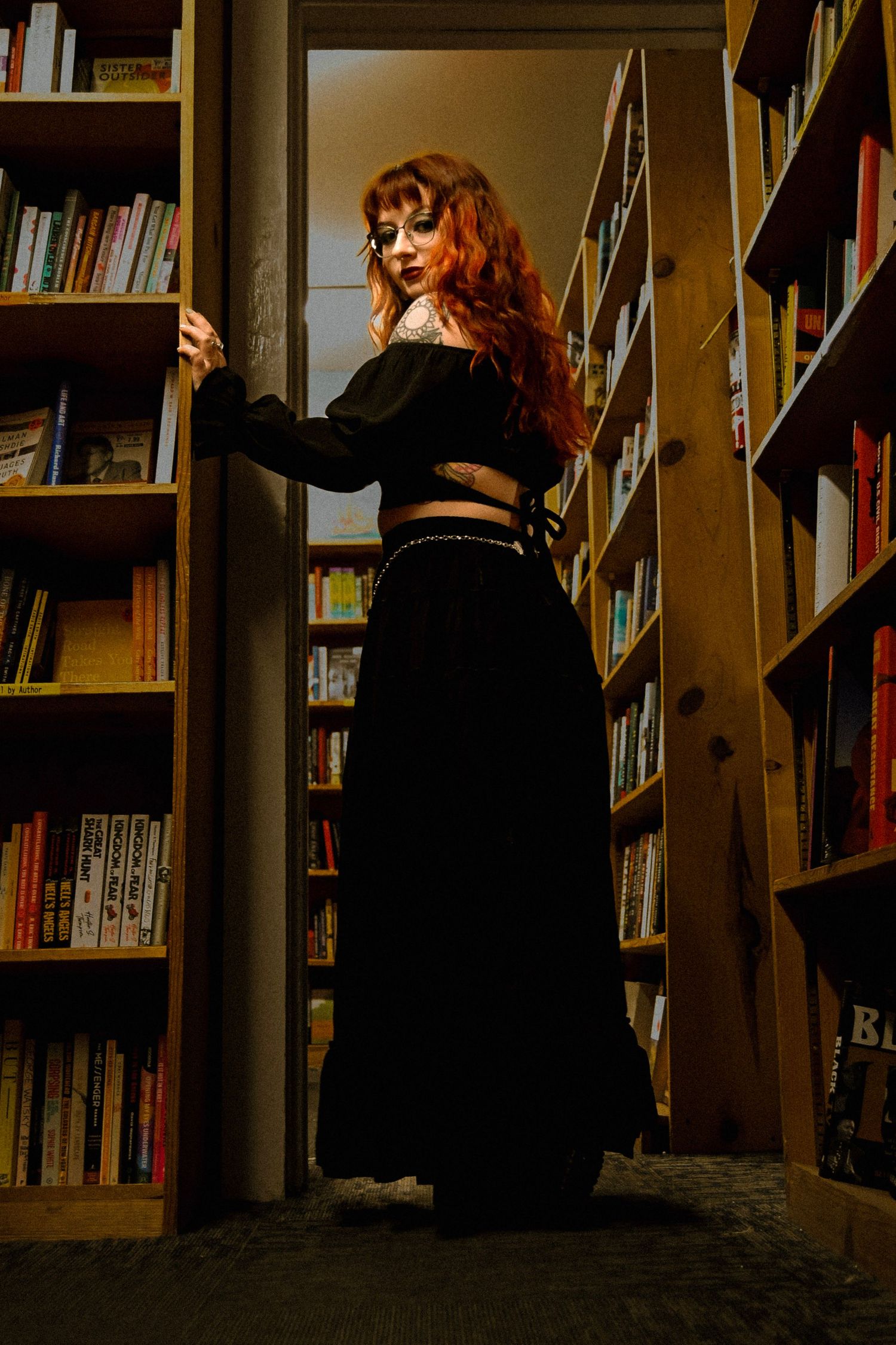 A sequence of photos showing someone browsing through library bookshelves in dramatic lighting.