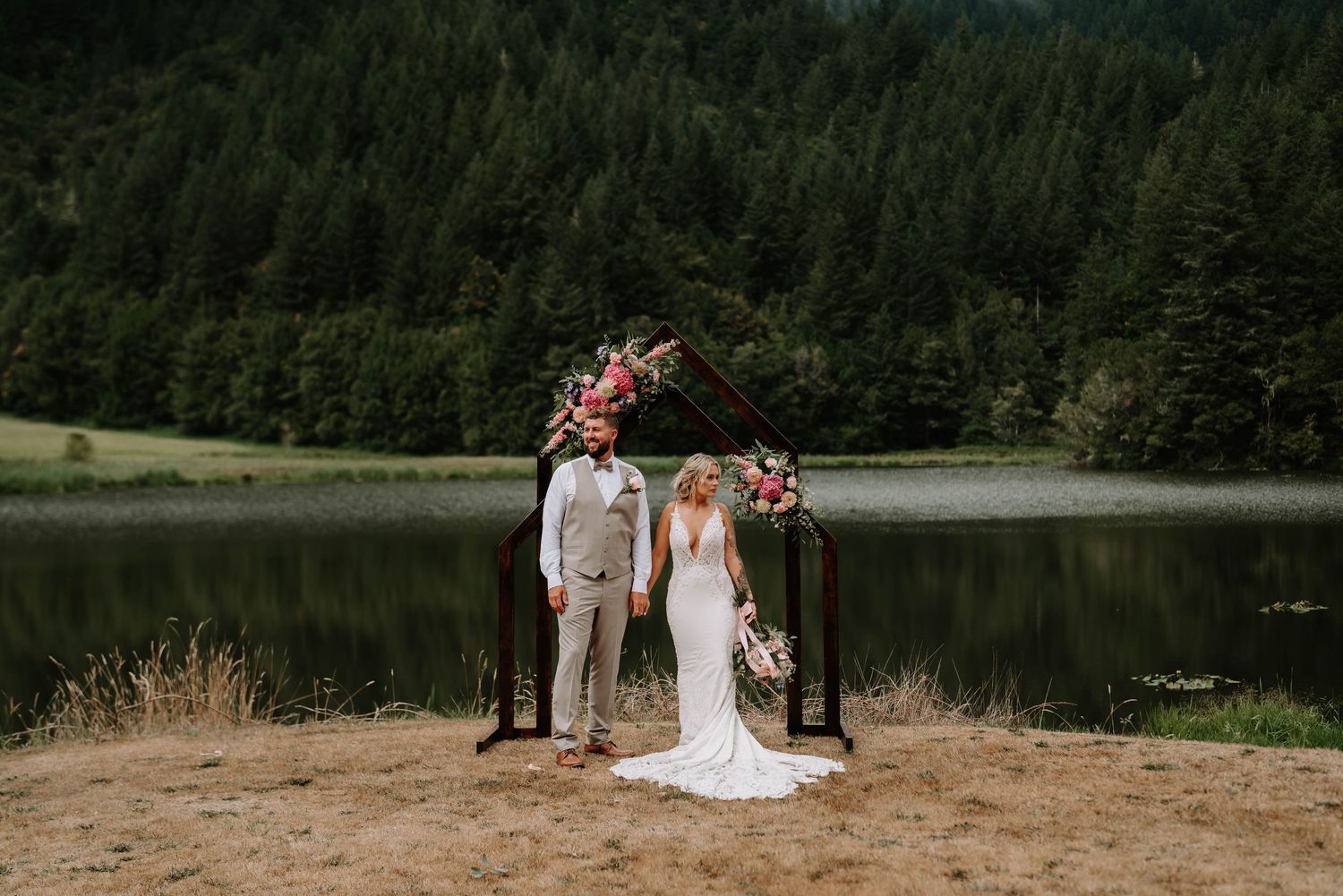 Scenic mountain forest backdrop frames an outdoor wedding ceremony setup.