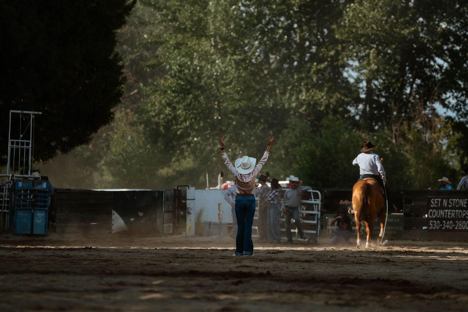 Rodeo grounds and outdoor arena with trees and equipment visible in a panoramic view.