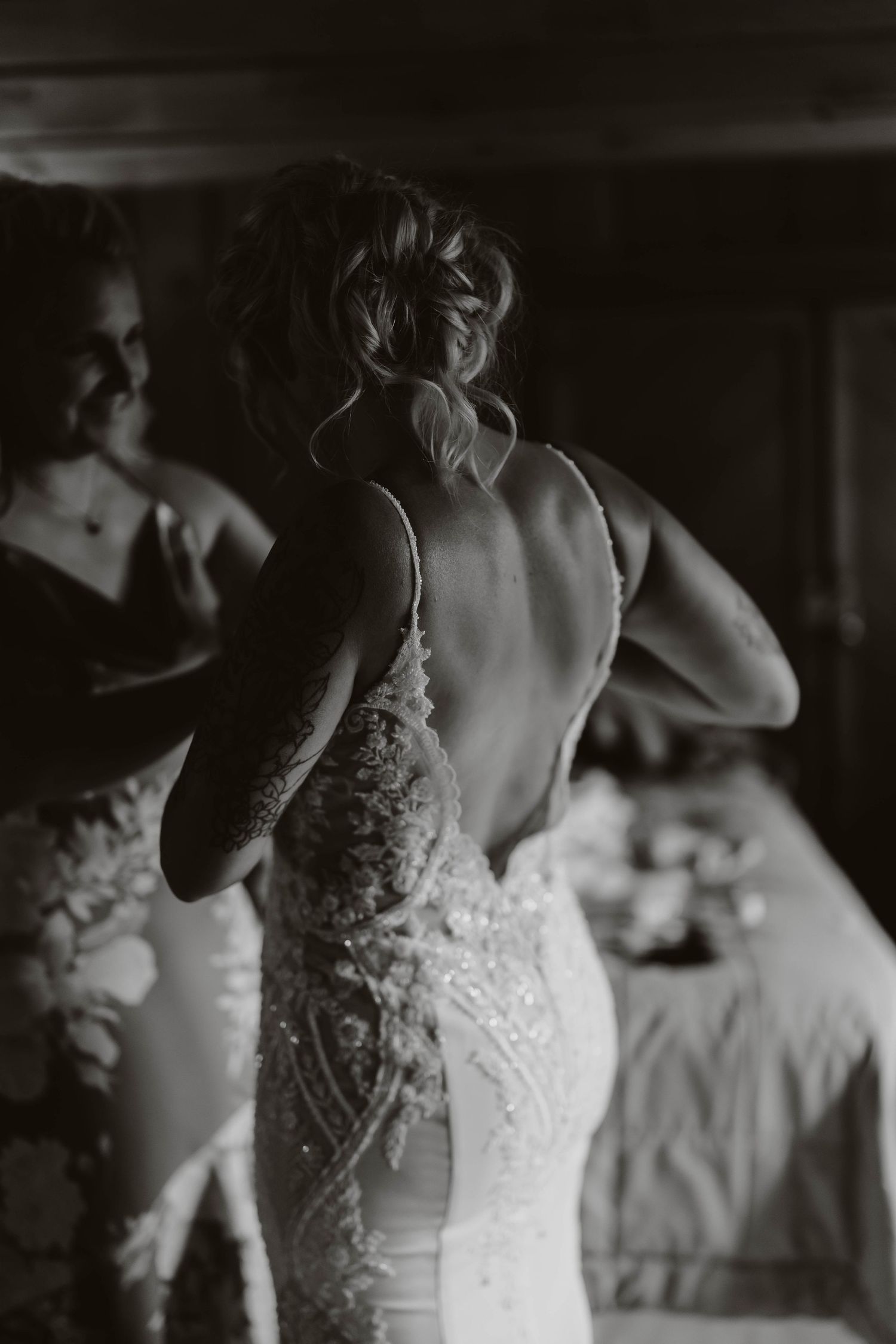 Black and white photo of an elegant lace wedding dress detail.