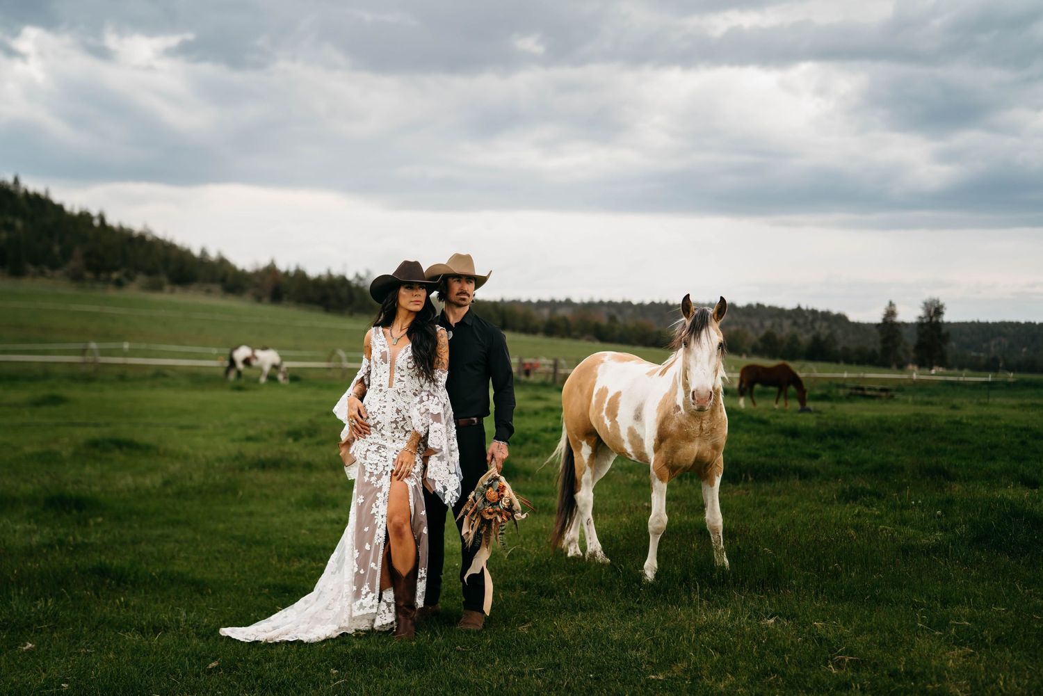 Oregon Wedding photography with horses in a scenic mountain meadow under cloudy skies.