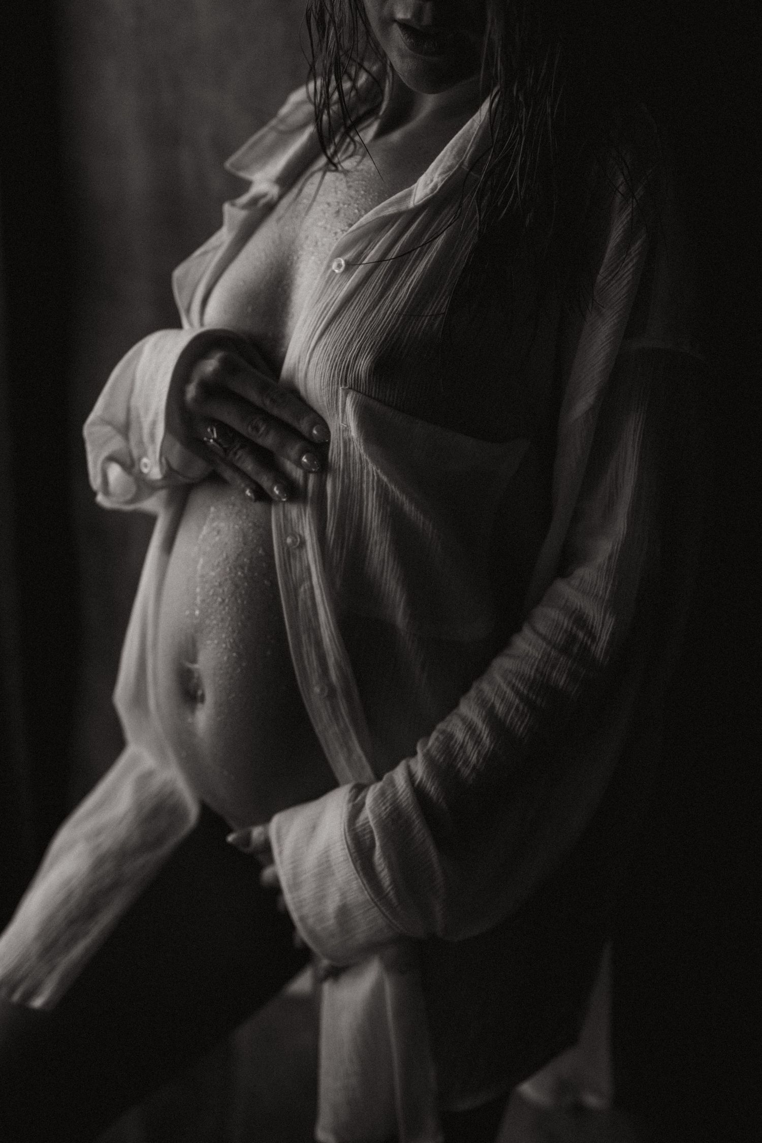 Artistic black and white boudoir photo series showing intimate poses in dramatic lighting.