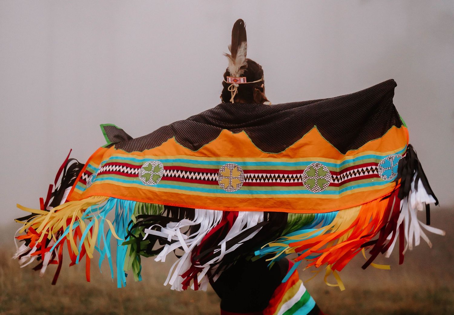 A colorful beaded Native American ceremonial piece displayed horizontally.