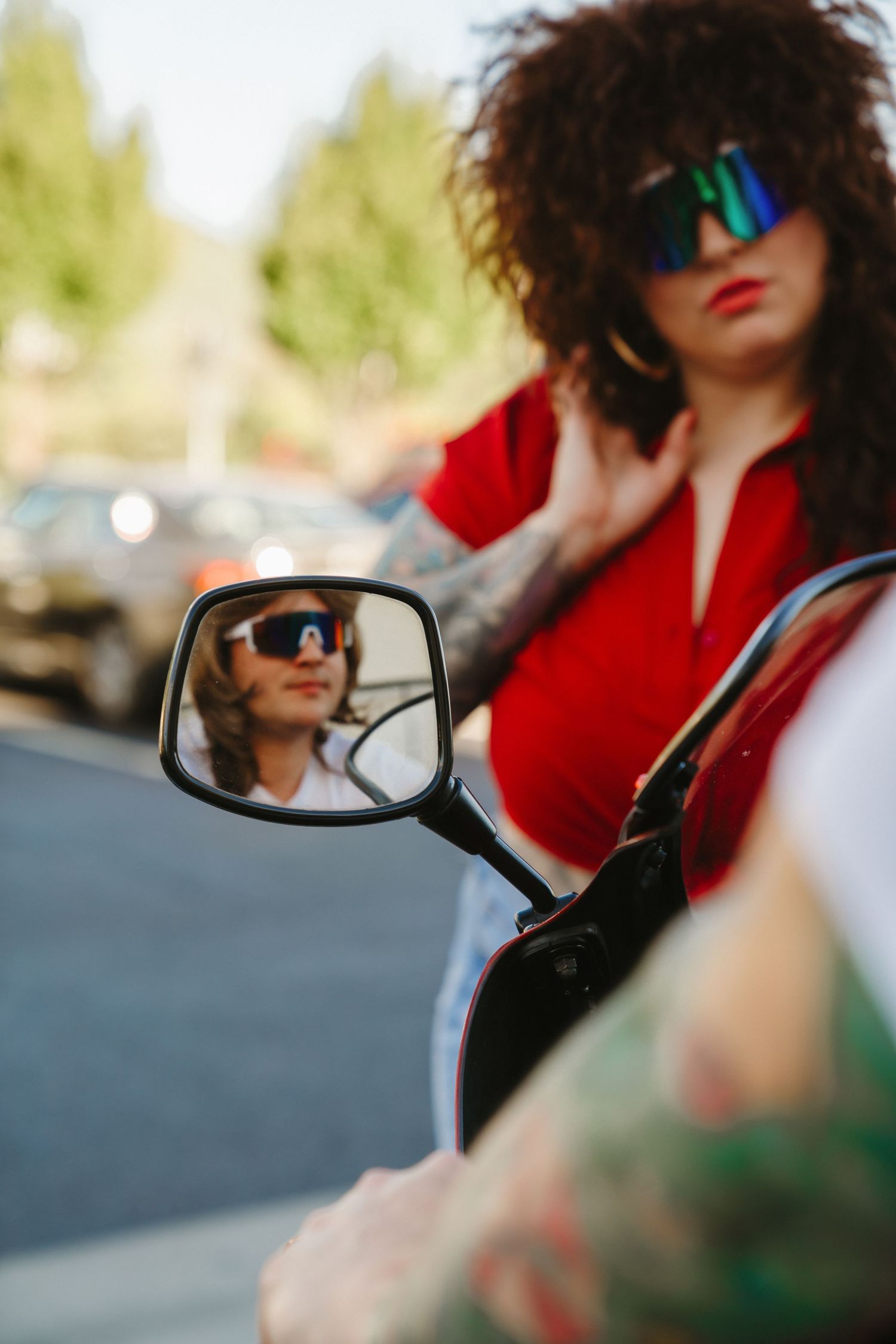 Artistic close-up shots of motorcycle side mirrors with reflective sunglasses.