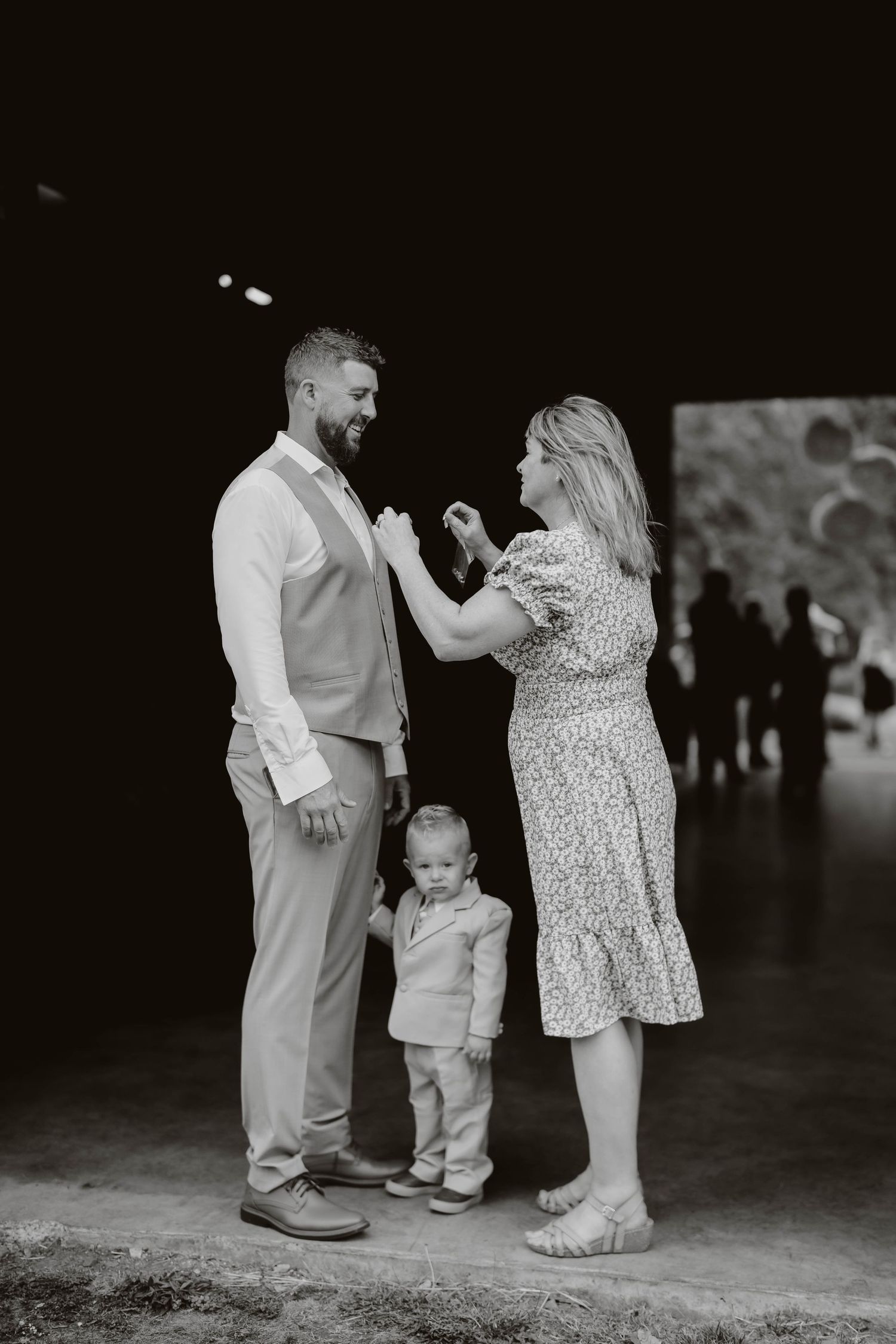 Black and white candid shots of family dancing together at wedding reception.