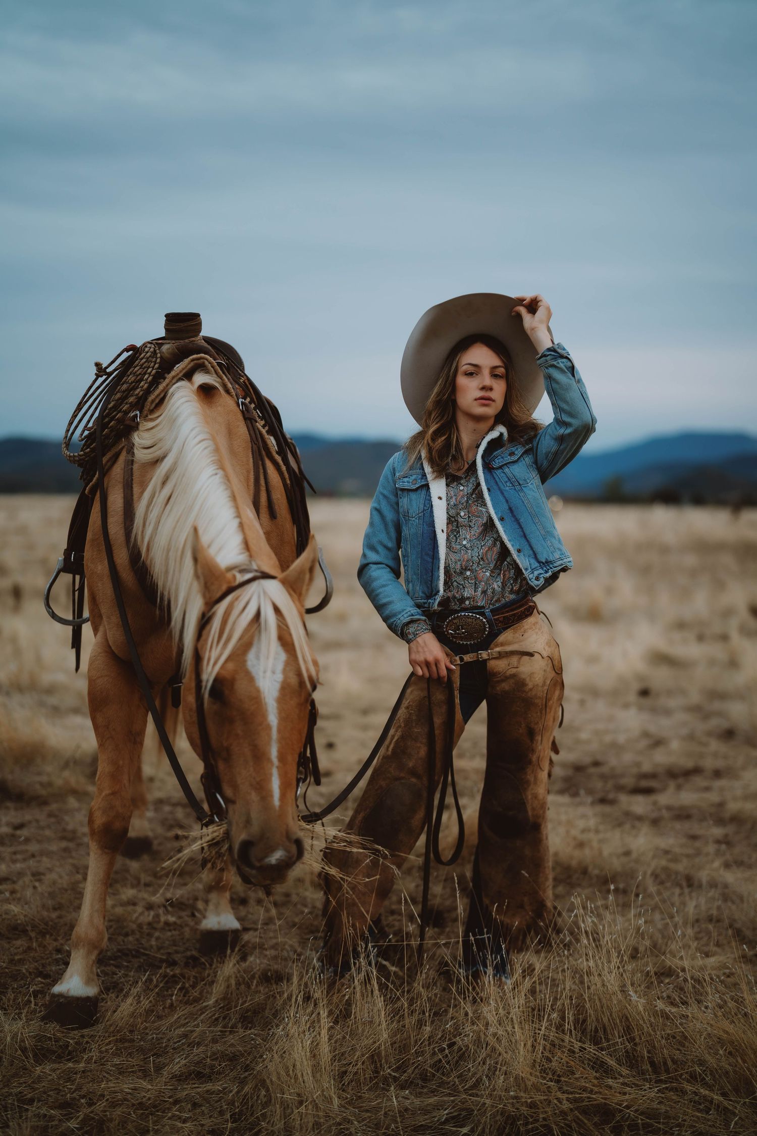 Moody western photography series featuring a horse and rider in rustic ranch setting.