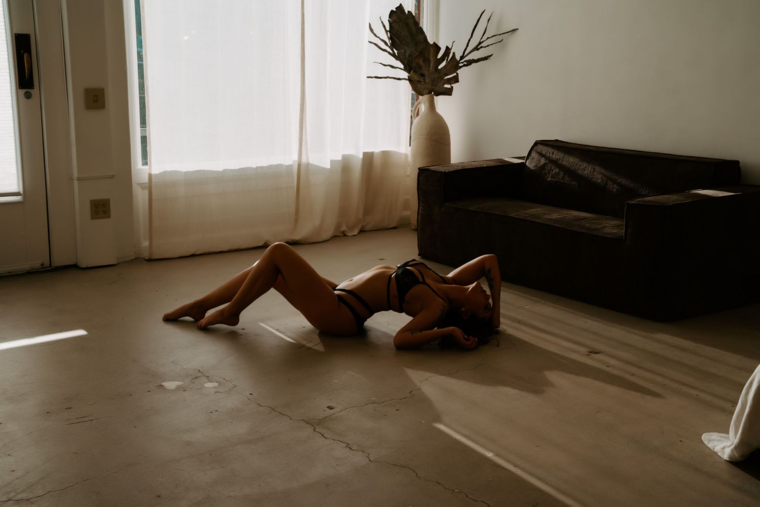 Artistic silhouettes against window light creating dramatic shadows on a wooden floor.