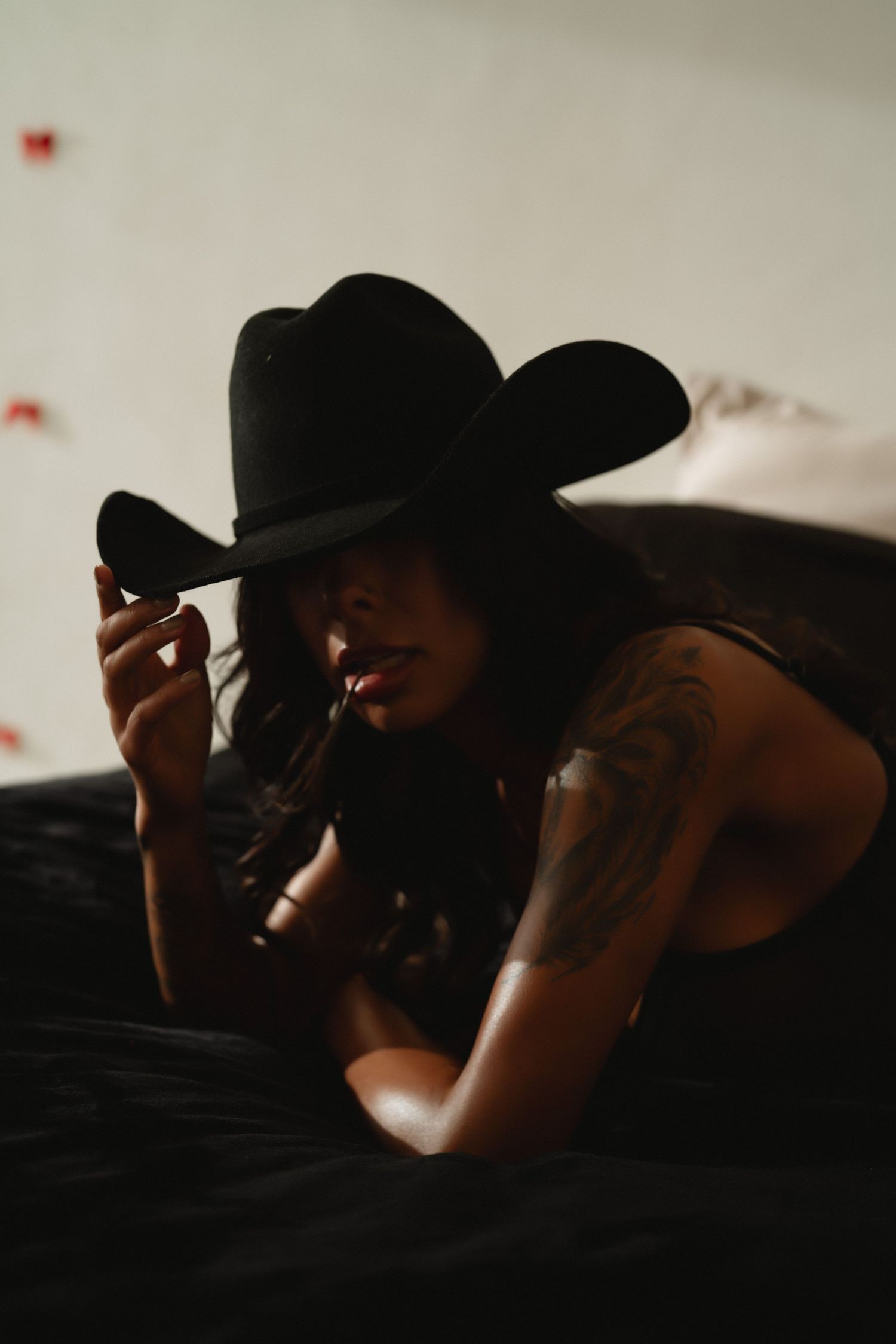 Dramatic low-light portrait series with cowboy hats in shadow.