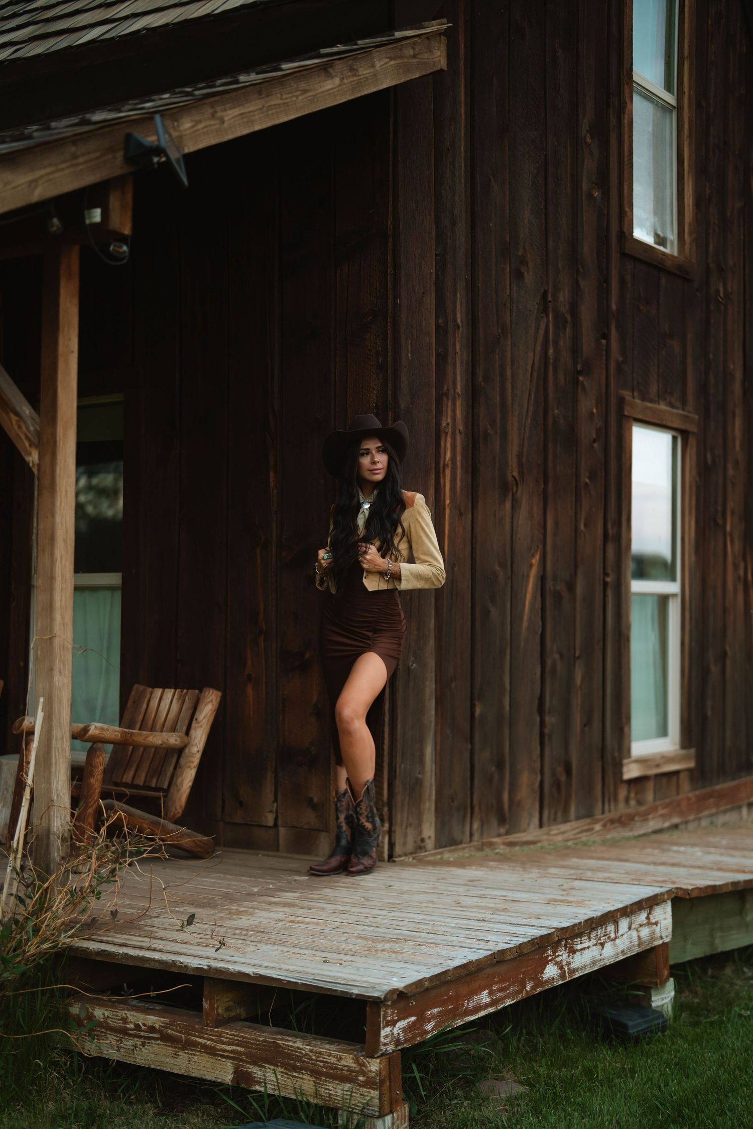 Series of shots showing a rustic wooden cabin with a wraparound porch.