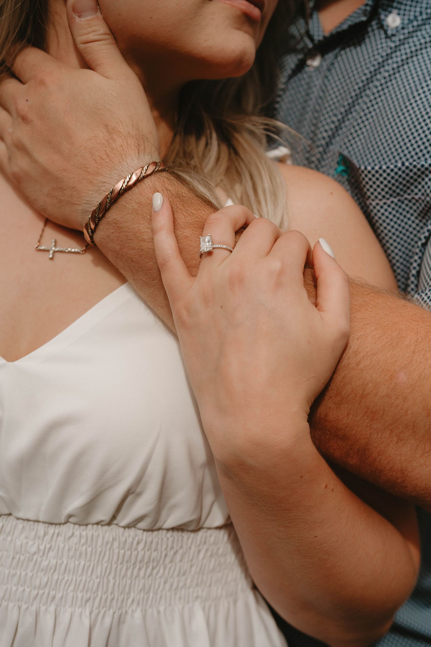 Close up shot showing a couple's hands and rings during an intimate romantic moment.