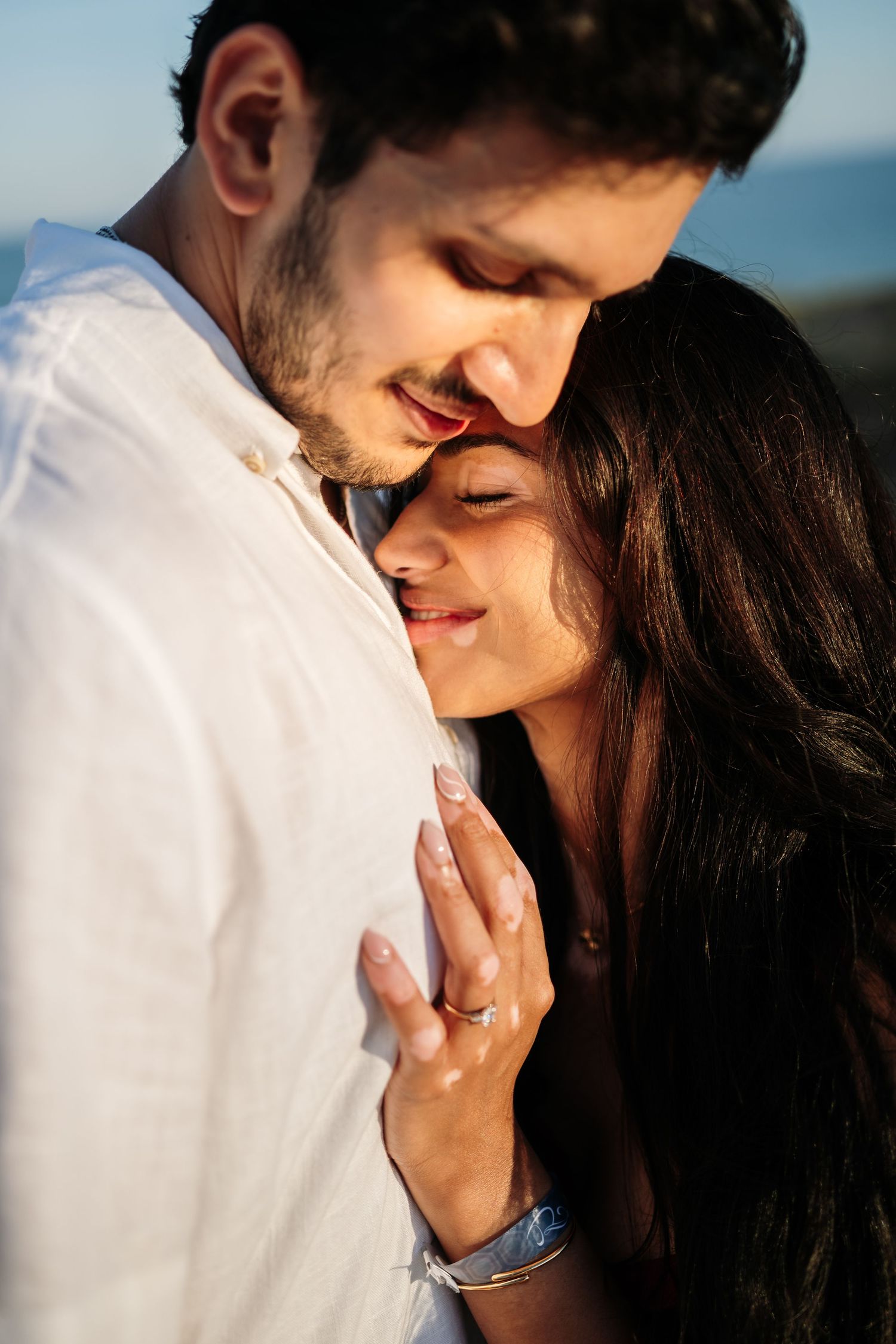 Close-up shots of an engagement ring and tender moments between a couple.